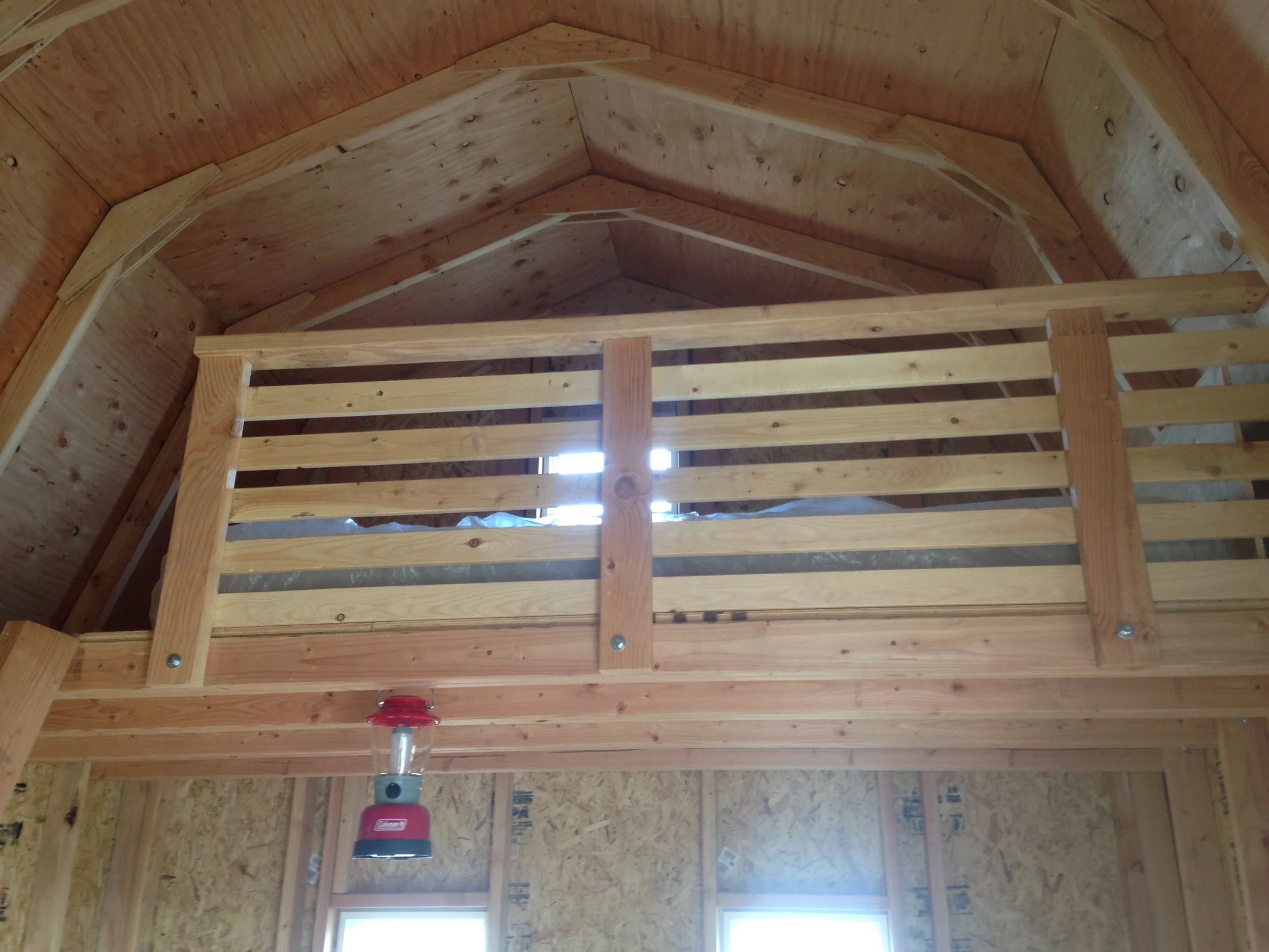 Leftover spruce furring strips (initially intended as window trim) make for an aesthetically pleasing and practical addition to the railing.