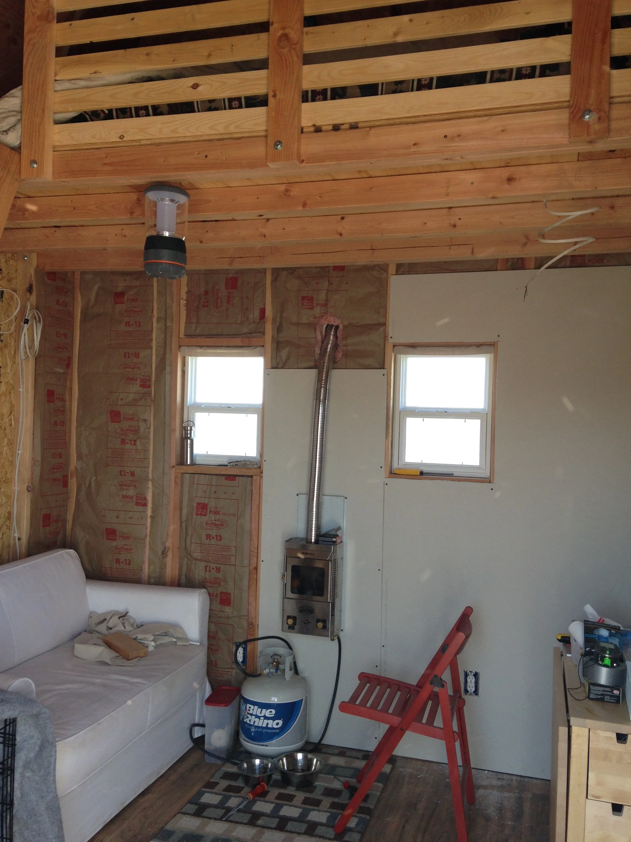 Insulation in place with a few drywall panels installed.