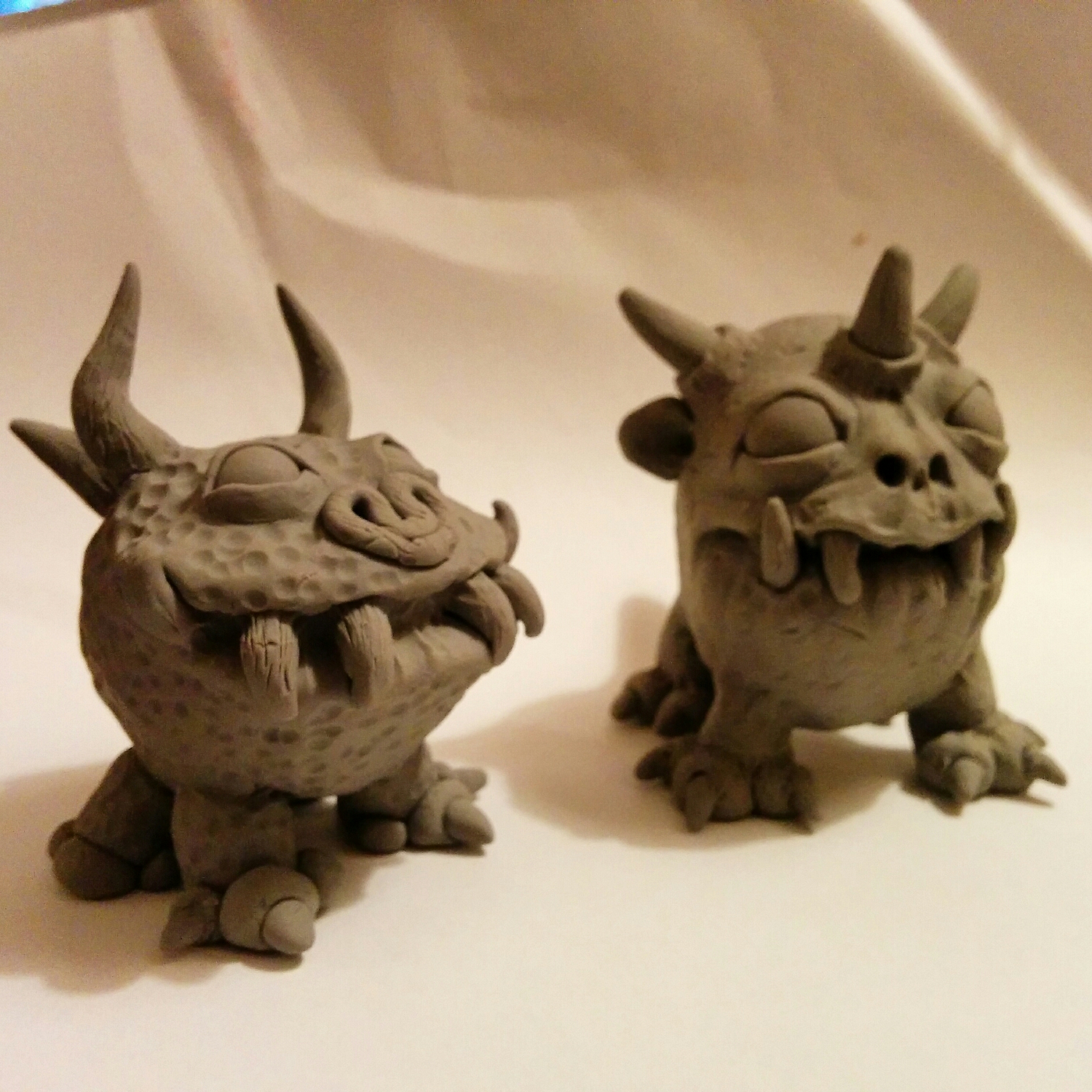 my sisters first super sculpey monster on the left, and my monsteron the left.