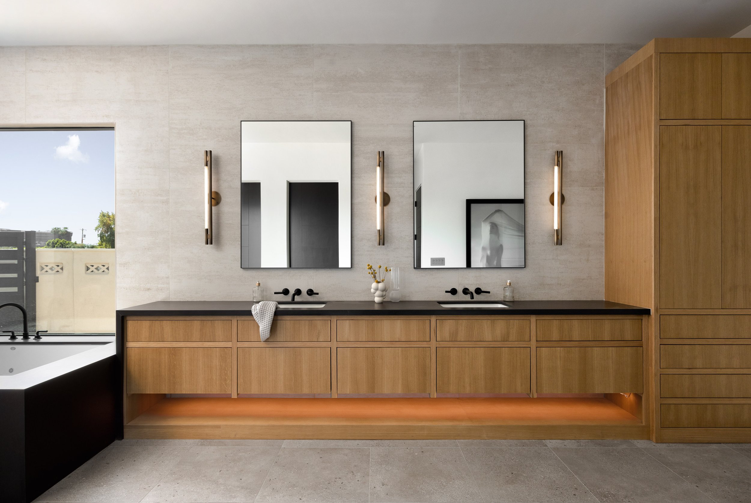  Minimal shape, maximum appeal. Three  Leto Sconces  featured in this modern bathroom designed by Kaitlyn Wolfe and photographed by Kevin Brost. 