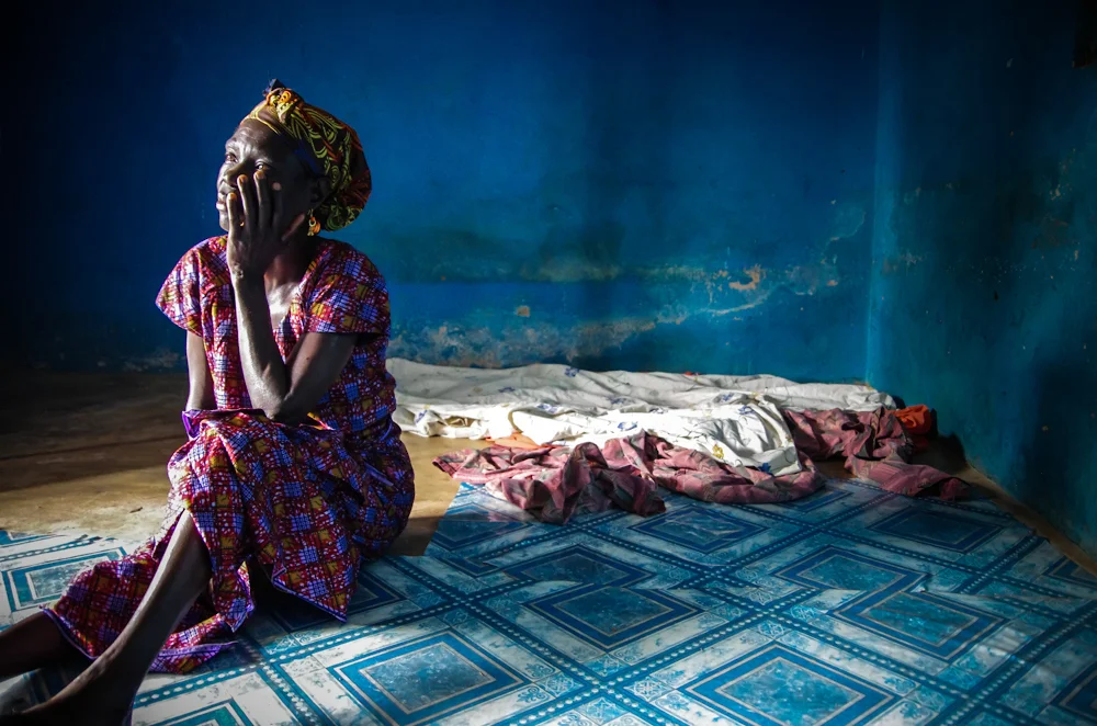 A Ghanaian woman sits inside her home near the town of Bekwai in Ghana's Ashanti region. She is HIV positive and a member of the Kaleo Area Women's Development Association (KAWDA), a community based organisation that supports people living with HIV/…