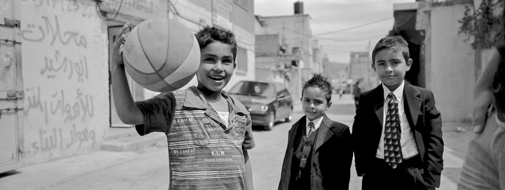  Bethlehem Palestine children at Arqoub refugee camp, still surrounded by wire fence and isolated in area b. Each area of the West Bank is designated according to Israeli or Palestinian control. © Haydn Denman 