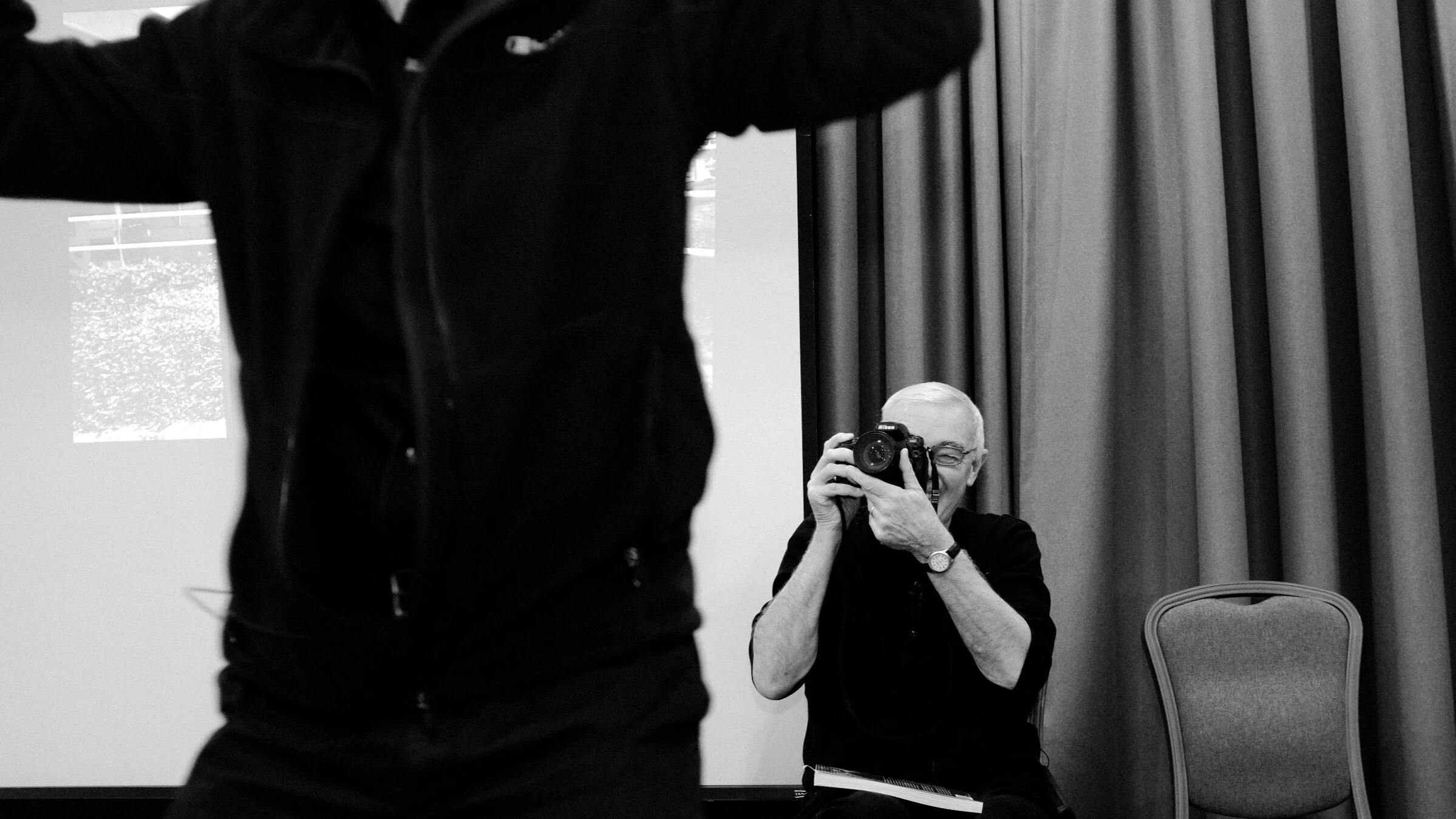 The animated Peter Finch describing the ‘psychic centre’ of Cardiff with photographer John Briggs capturing the moment. Image © Brian Carroll