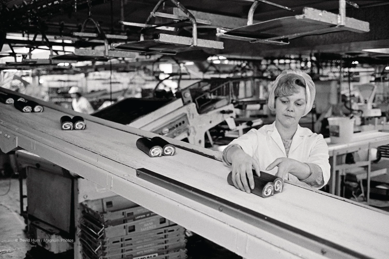 Image of a female worker on the cake production line at Avana Bakeries, Newport, 1973  © David Hurn / Magnum Photos