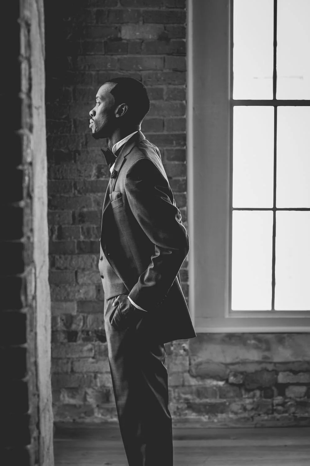 Groom looks onwards as he awaits his wedding day at The Cotton Room in Durham, North Carolina. 
