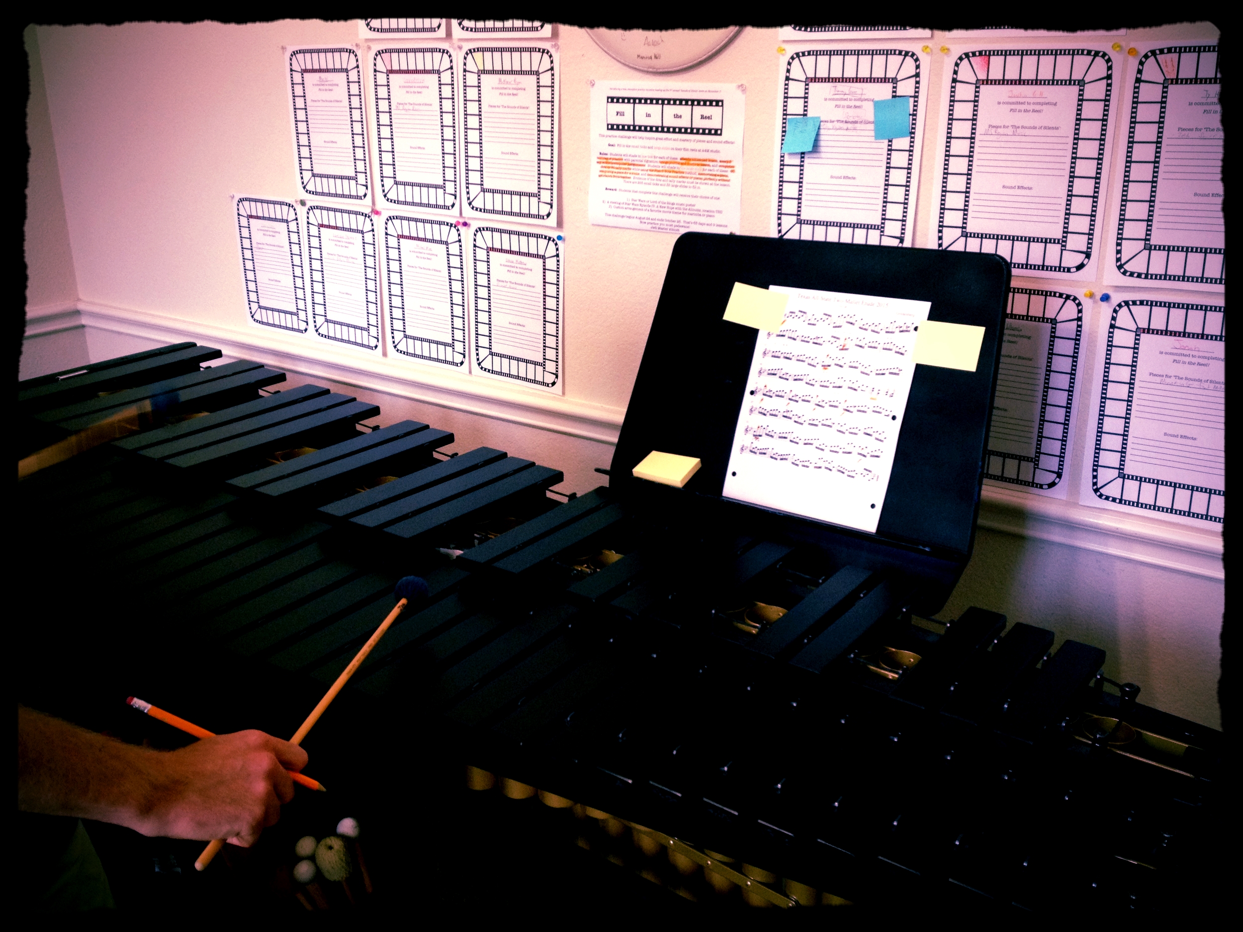 Roger practicing the marimba with mallet and pencil in hand. 