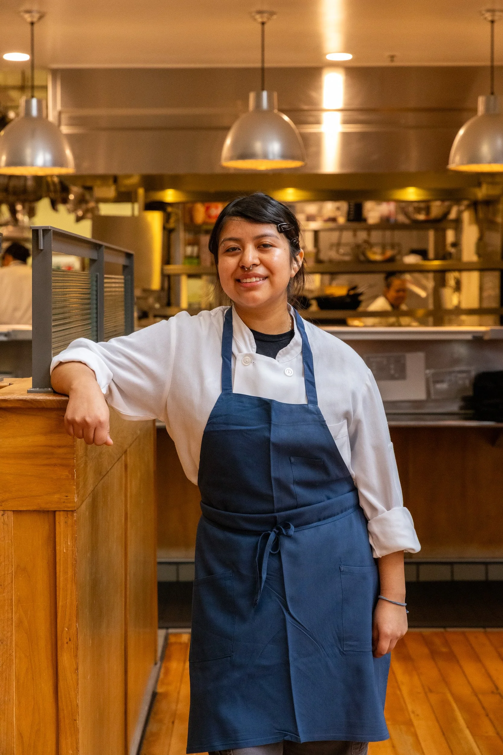 Student in blue apron in Sprouts Chef Training