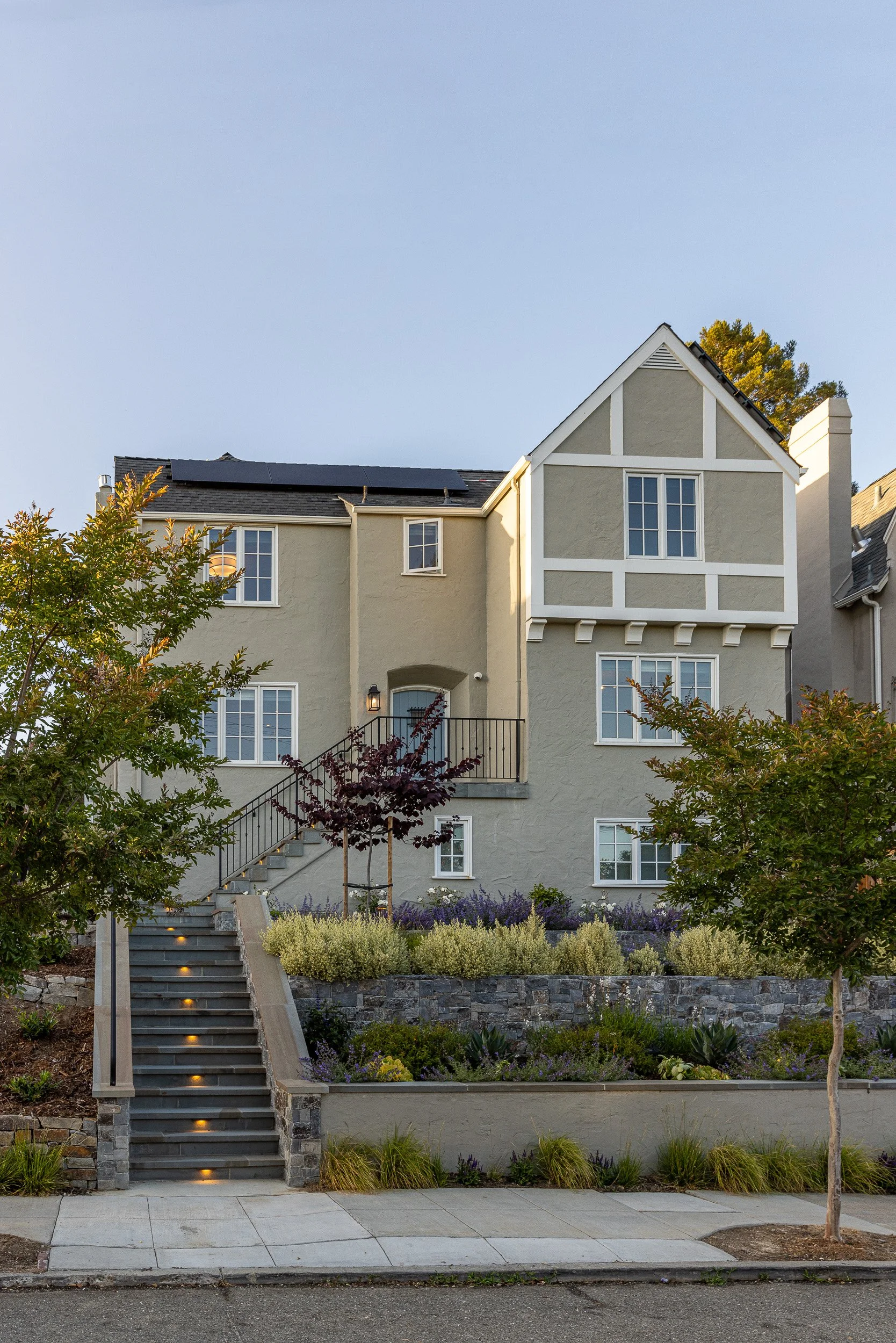 Tan house exterior by Lazar Landscape Design and Construction