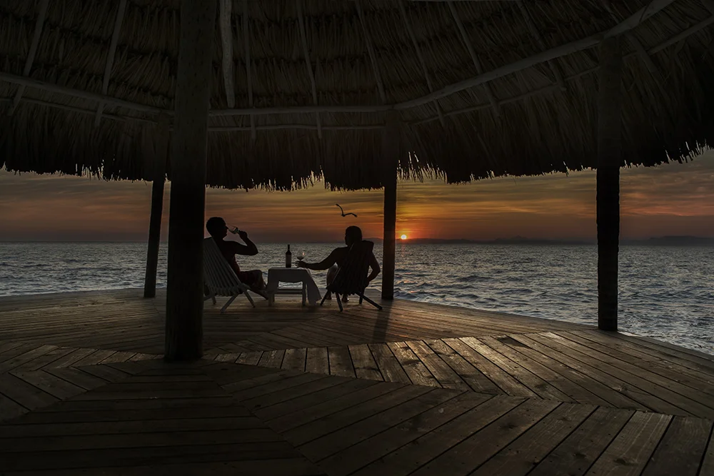 thatch caye wine at sunset on serenity point.jpg