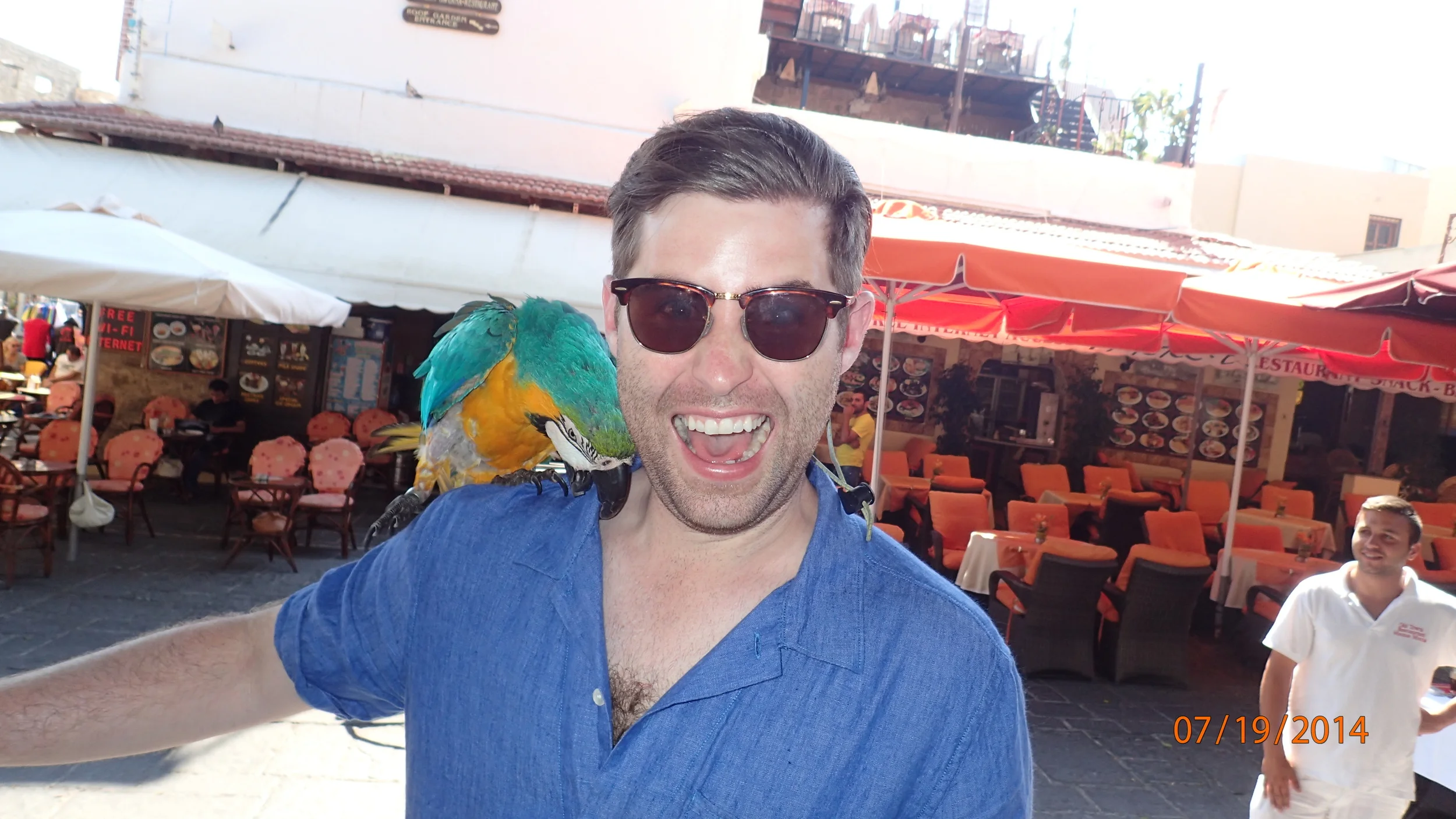 Tyler was too afraid to hold the parrot in Rhodes.