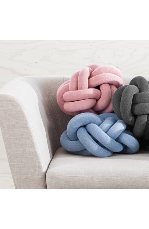 A soft knit-fabric tube is intricately looped and knotted to make a cozy, chunky cushion that's both chic and charming.