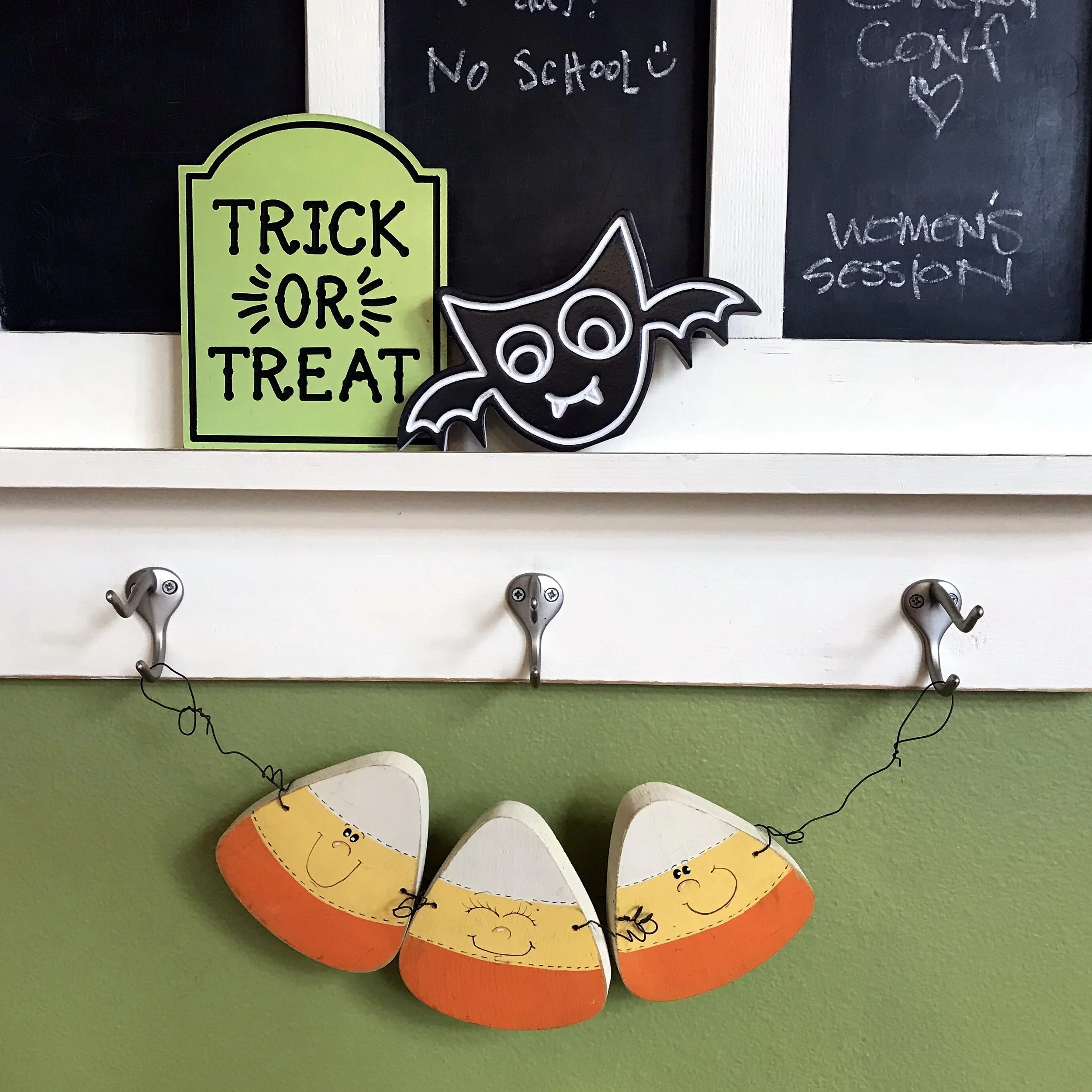 I painted this candy corn trio back in 1994-ish and it has hung on the hooks of our weekly blackboard calendar for as long as we’ve lived in this home. The other two are from the Target dollar spot a few year back and they sit on the narrow shelf.