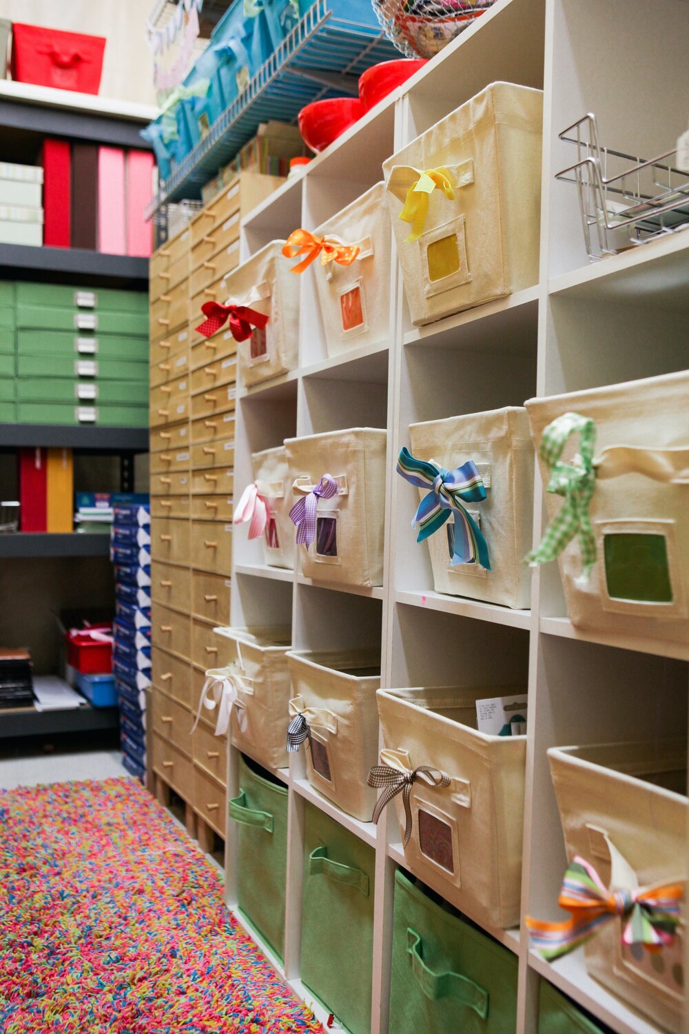 This image of my storage room—which sits behind my creative studio—is not up to date, but still reflects the shelves that hold bins of scrapbook embellishments, stored by COLOR.