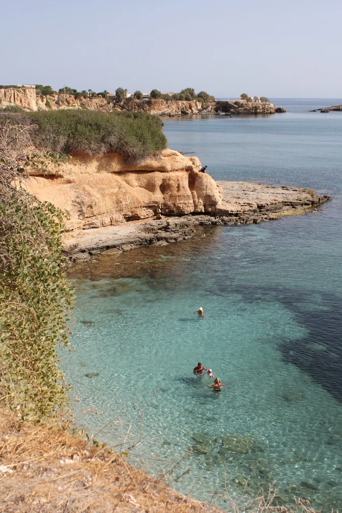 Somewhere on the North shore of Crete, nestled just off the edge of a red clay cliff, you'll find a white pebble beach with a crystal clear turquoise sea and beds sitting just in the water. We think it might be our favorite beach ever. It was really small and really peaceful with lots of stones for throwing and shallow waters for swimming and it was just perfect.