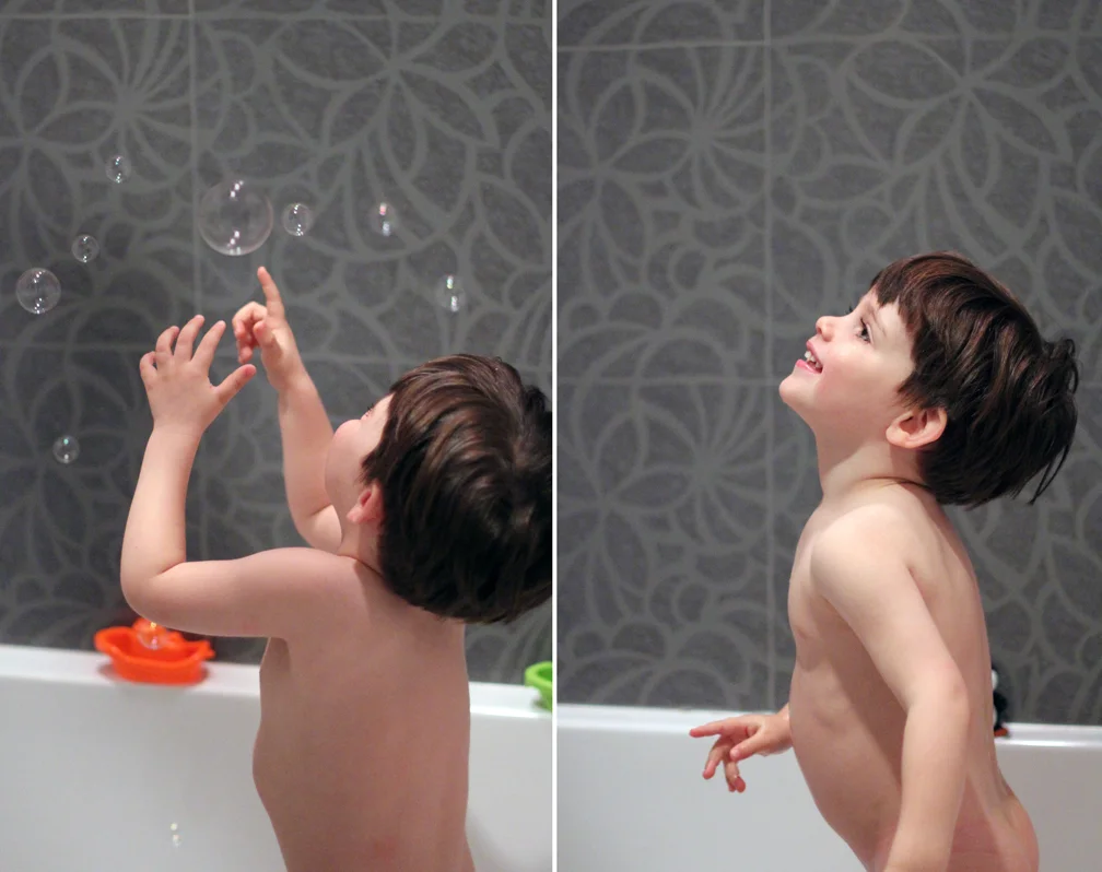 Popping bubbles is Everett's newest favorite activity... second only to squeezing himself in between two items (like the baby's tubby and the actual bathtub wall) and saying "Oh no! I'm stuck! I'm stuck! Help!" and pretending that Mommy has to rescue him. 