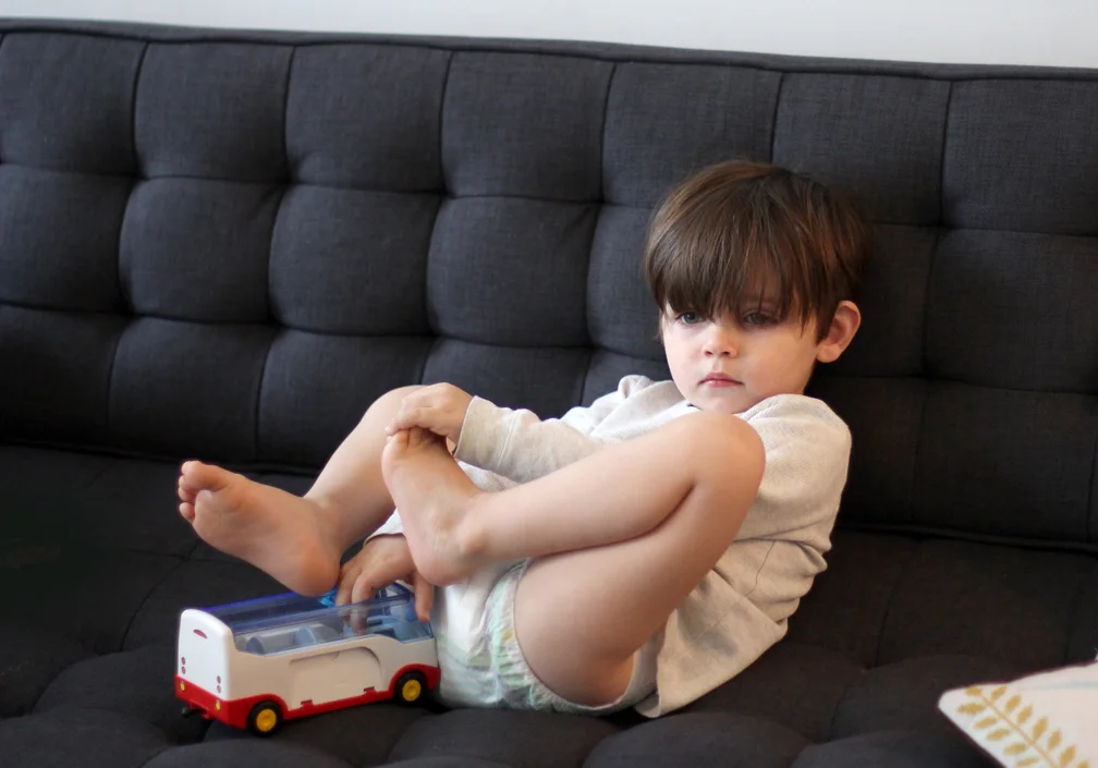 Everett watched a movie on Sunday. Not sure what happened, but somewhere along the way he lost his pants and curled up like a pretzel. I love his very, very serious expression. 