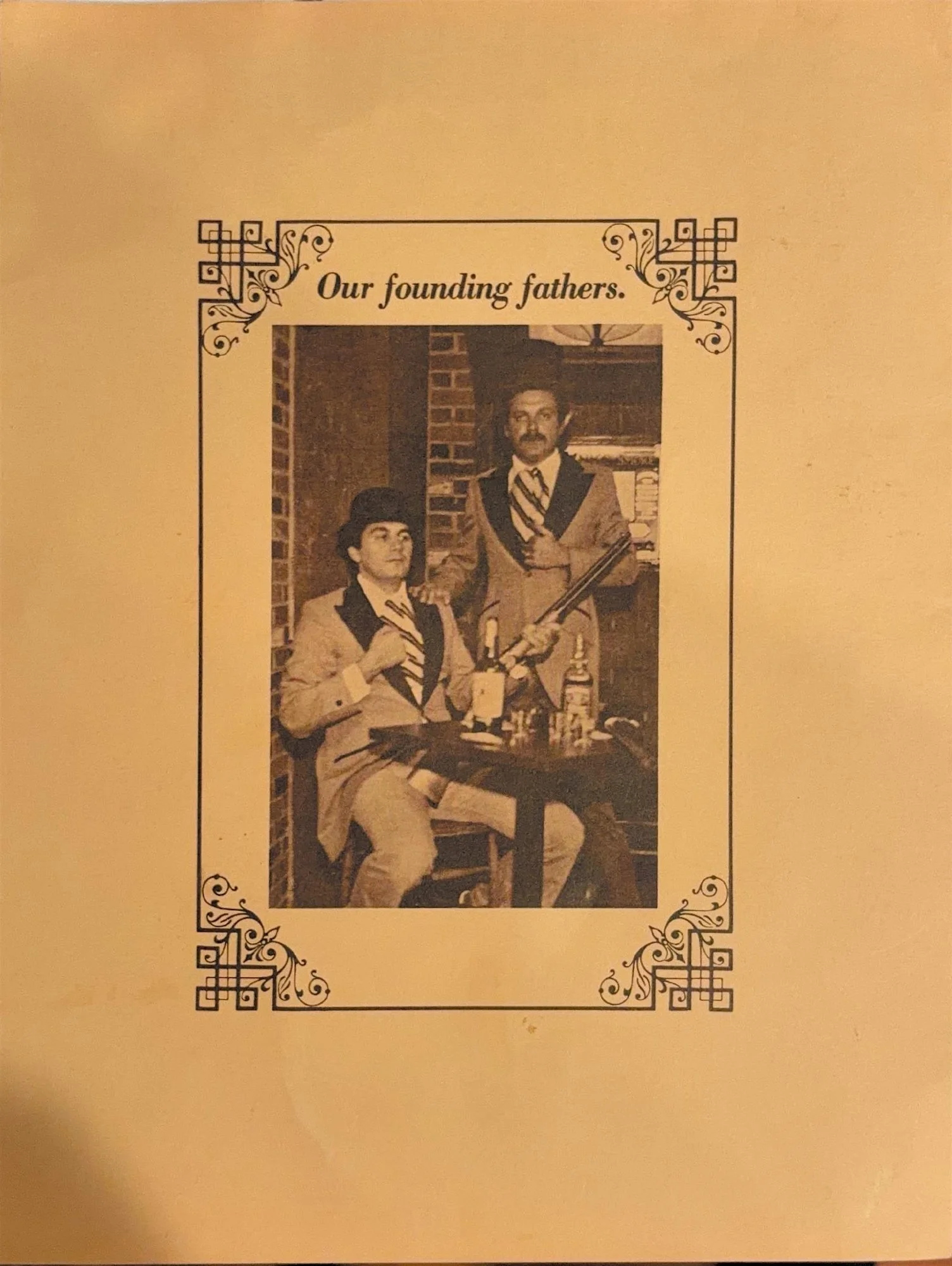Back page of the early Saloon menu: a sepia photo captioned 'Our founding fathers,' two men in period costume at a table