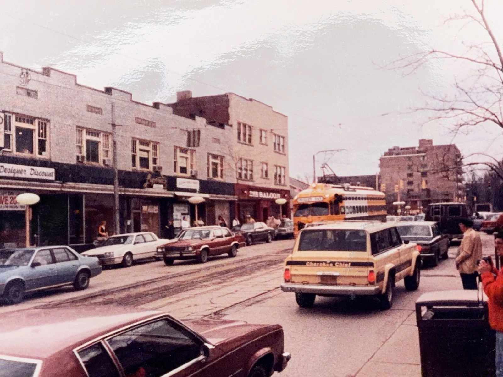 A yellow trolley passing The Saloon on Washington Road in Mt. Lebanon, 1980s