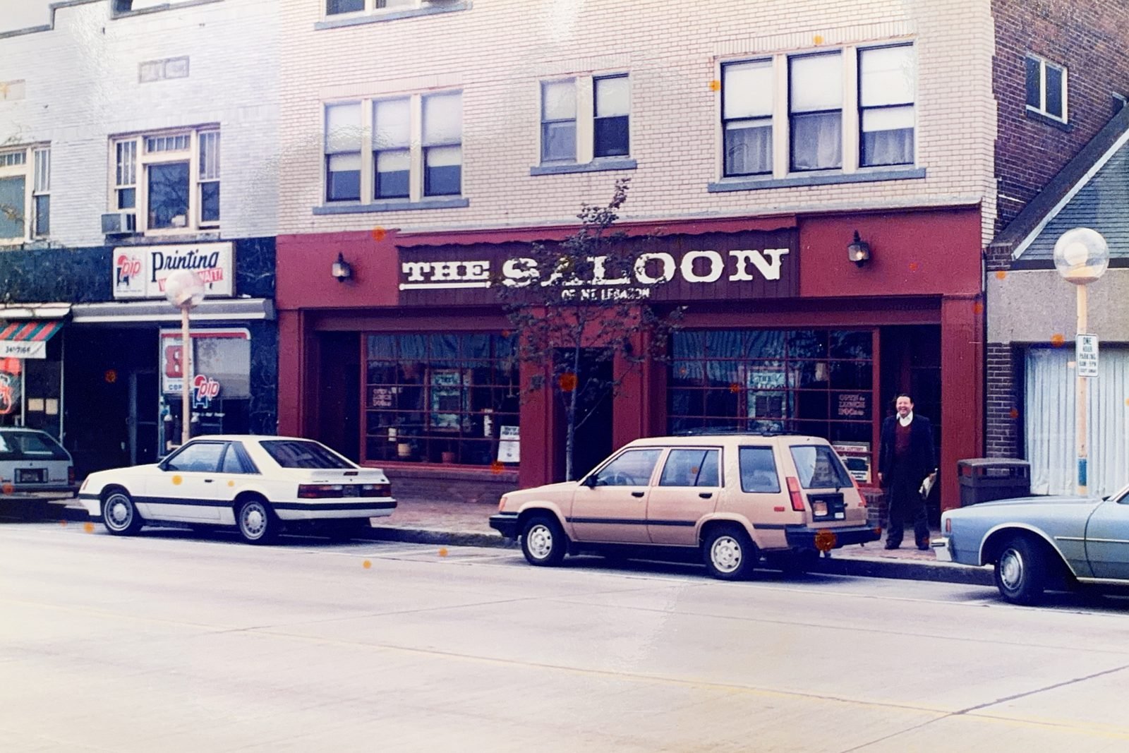 The Saloon of Mt. Lebanon's red storefront on Washington Road in the 1980s, with period cars parked out front