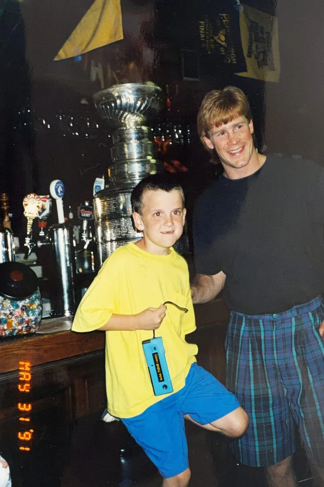 A young Keith Sheppard with Pittsburgh Penguin Troy Loney and the Stanley Cup at The Saloon's bar, May 31, 1991
