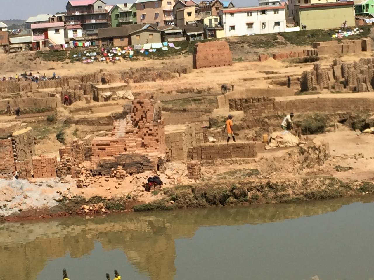 Clay for brick making is extracted from the river bed along the road to Antananarivo. The bricks are fired in kilns on site, fueled by wood burning.