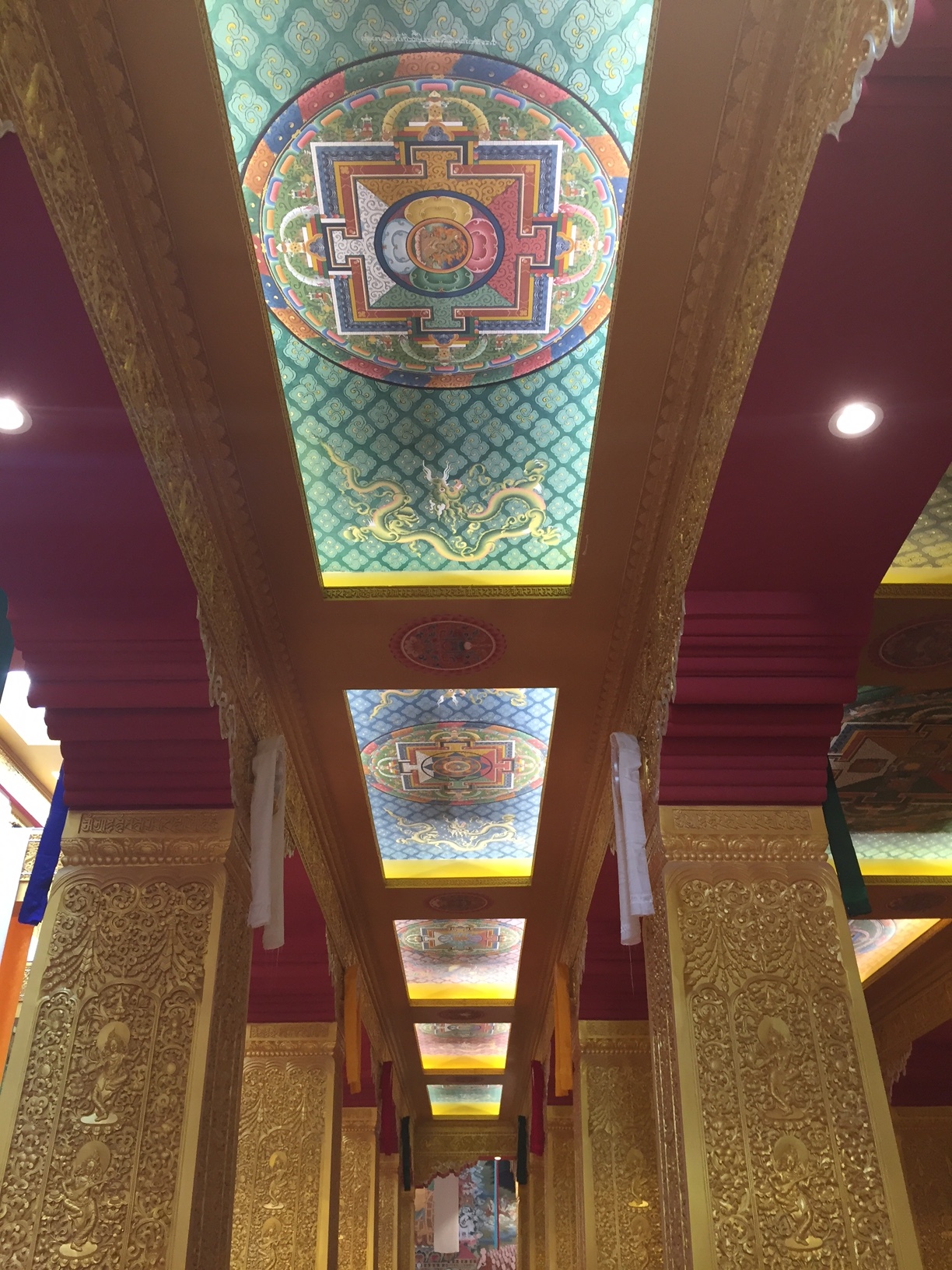 Looking up at the ceiling of the Buddhist temple supporting this gigantic Buddha statue.