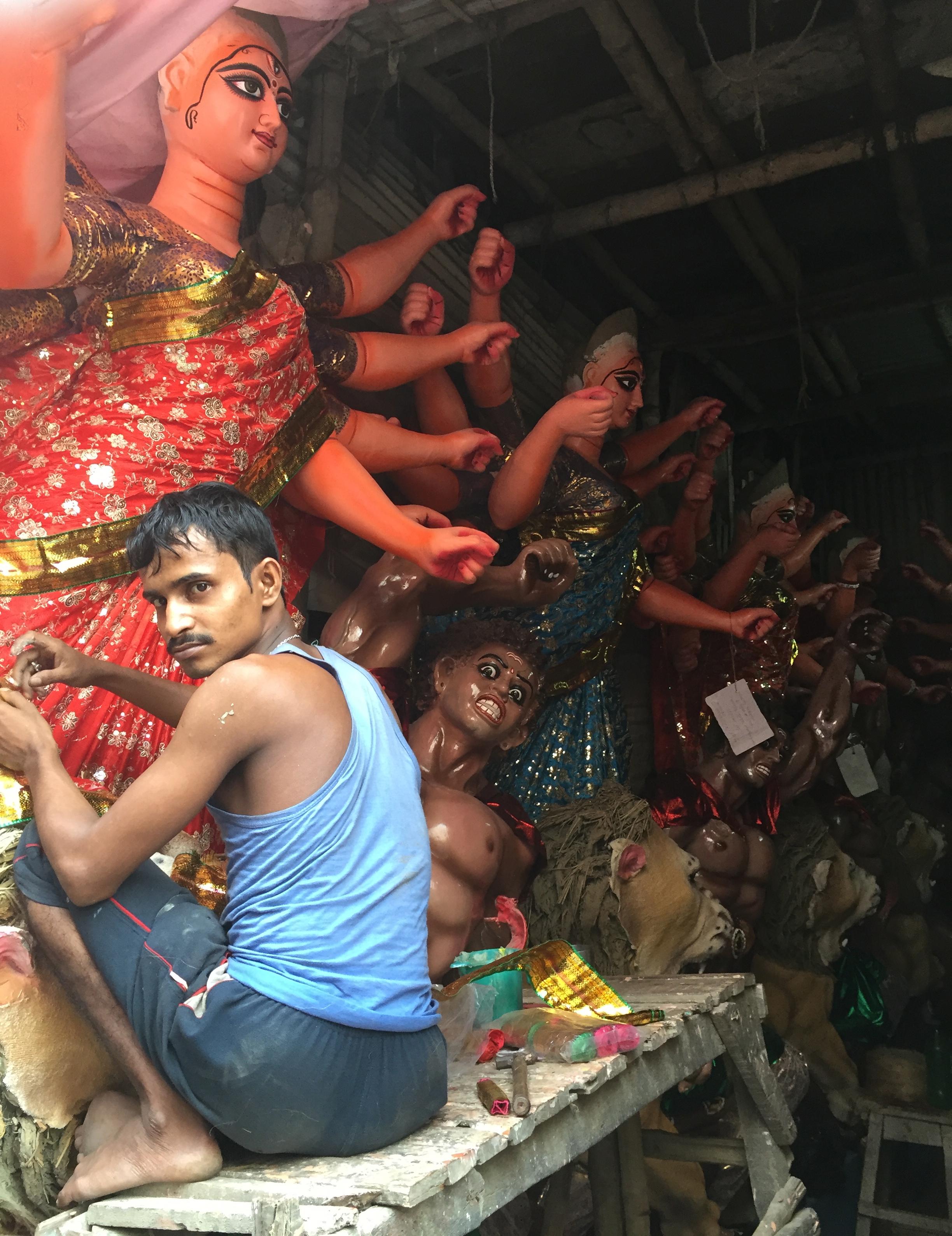 Artisan working on finishing statues for upcoming festival in Kolkata.