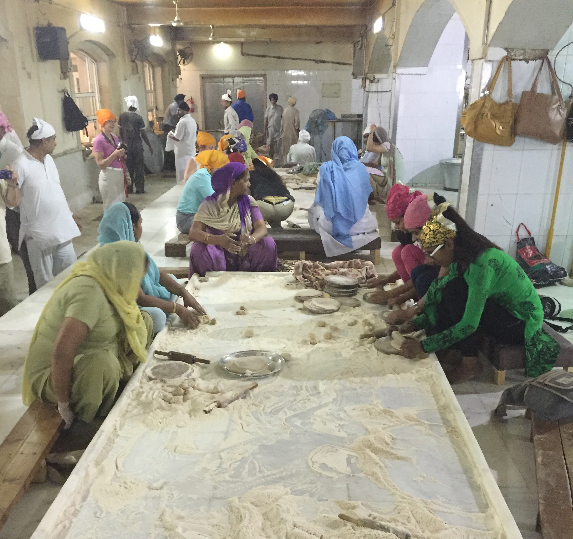 Volunteers knead dough for the countless chapatis served here every day.
