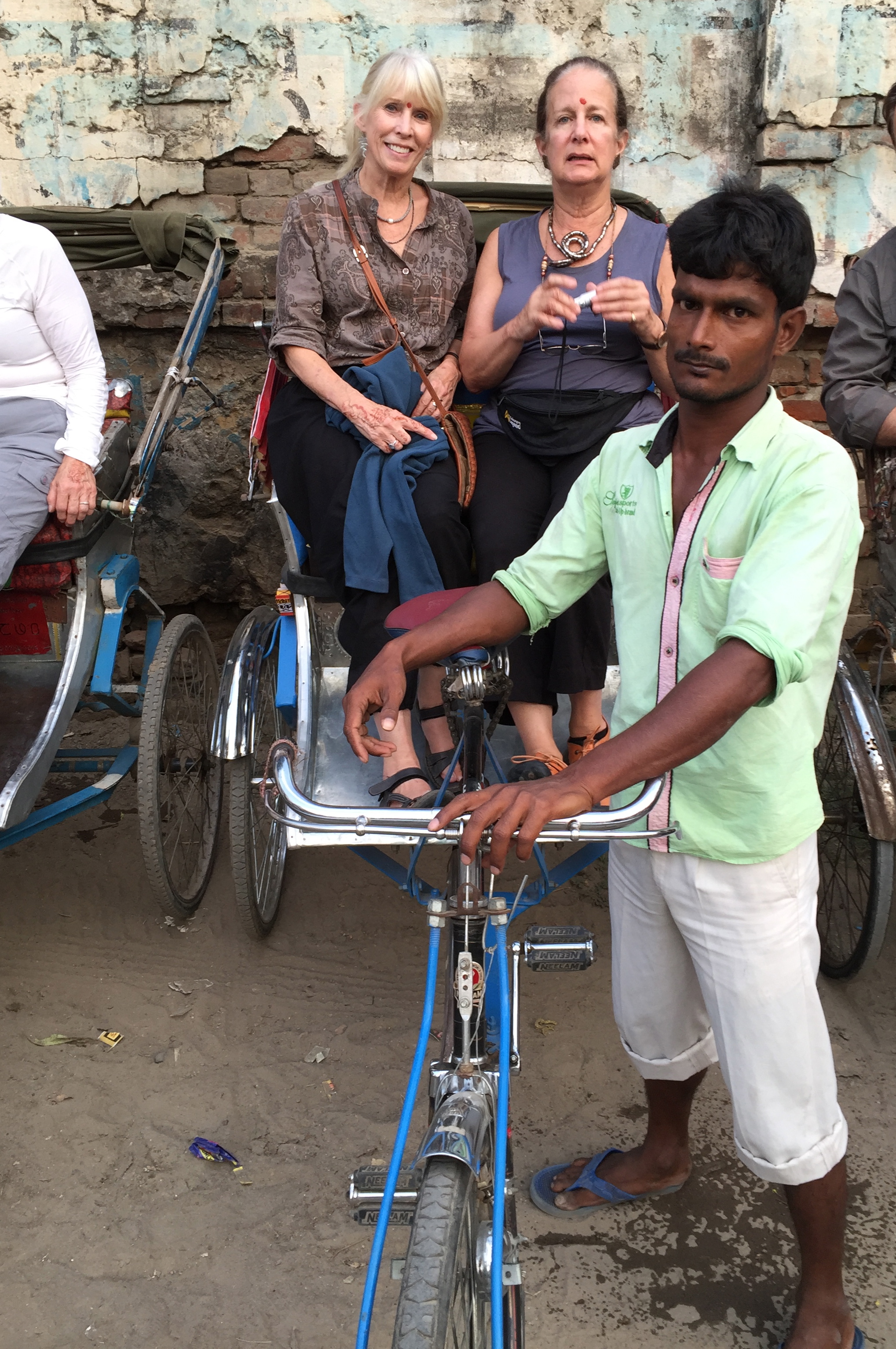 I'm seated with my friend Nina in a bicycle rickshaw, getting ready to travel through Old Varanasi to the Ganges boat launch. The return trip would be hair-raising...