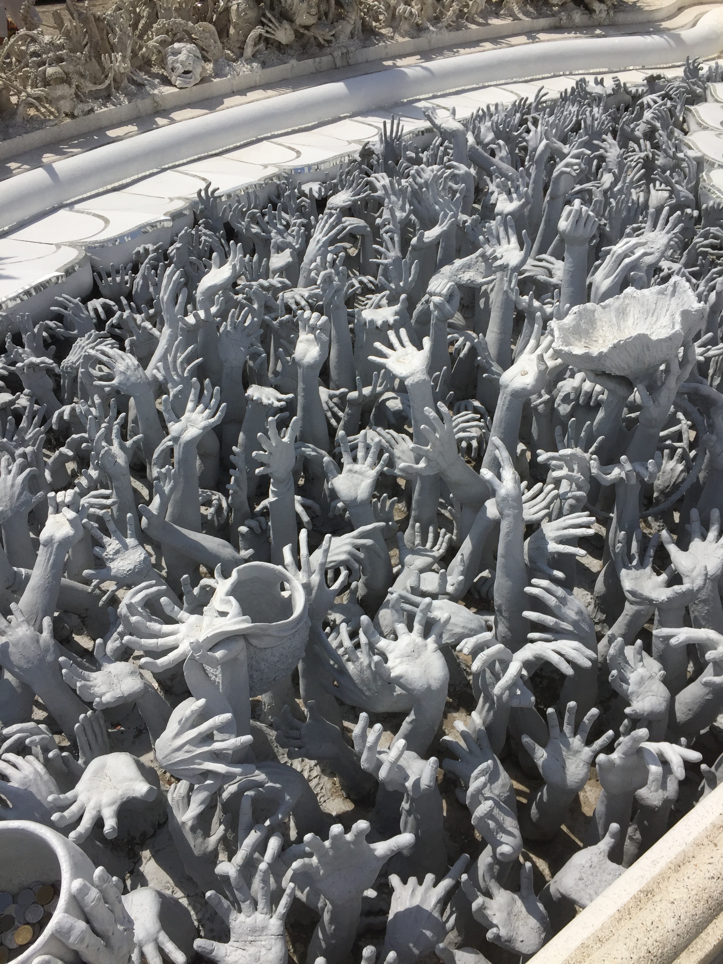 Parting shot of Thailand...a sculpture outside of the White Temple in Chang Rai, seeking donations to the venue.