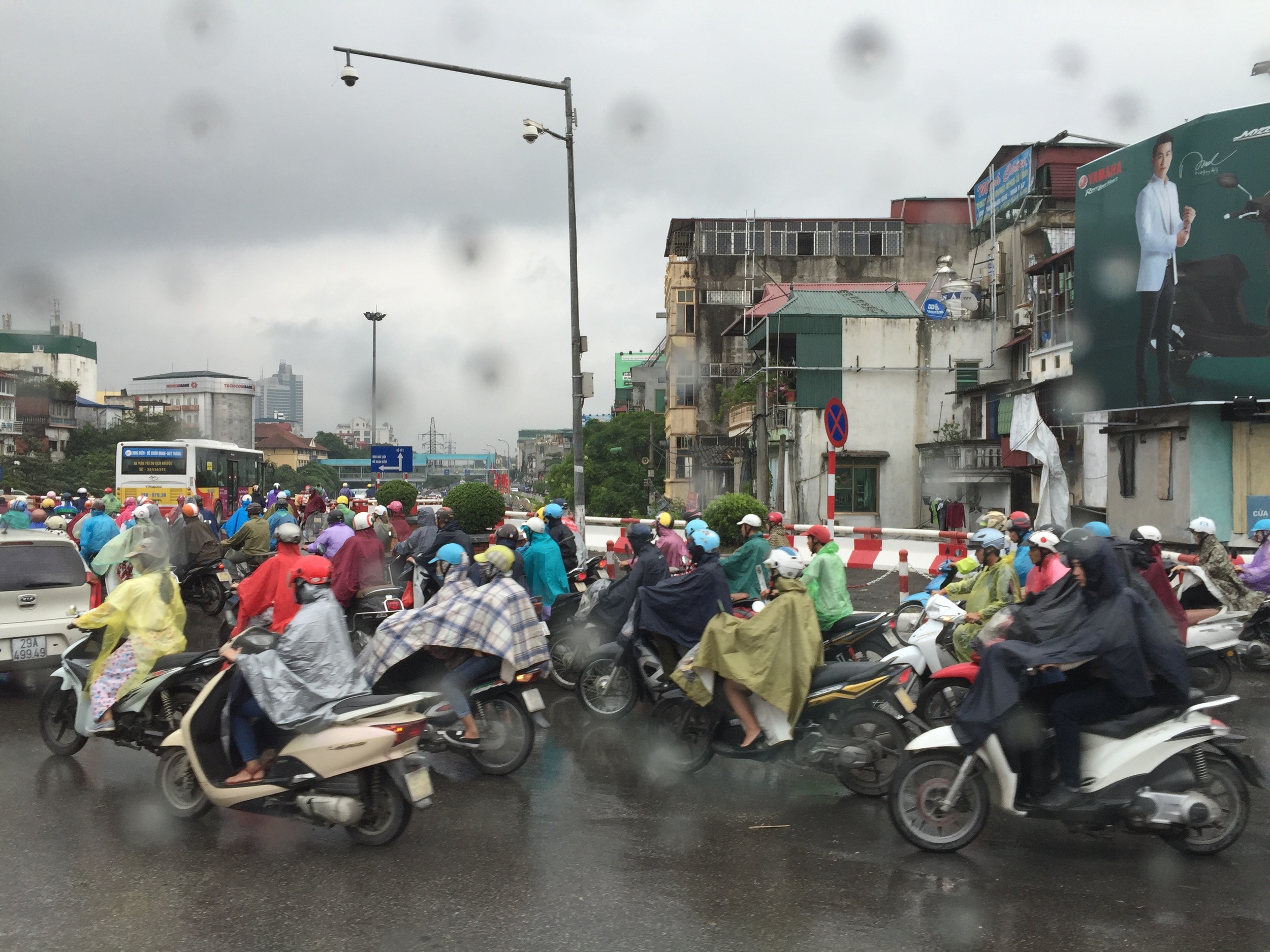 Everybody apparently rides a motorbike in the cities of Vietnam. Here in Hanoi, poncho-clad motorbikers barely seem to notice the downpour as they forge ahead.