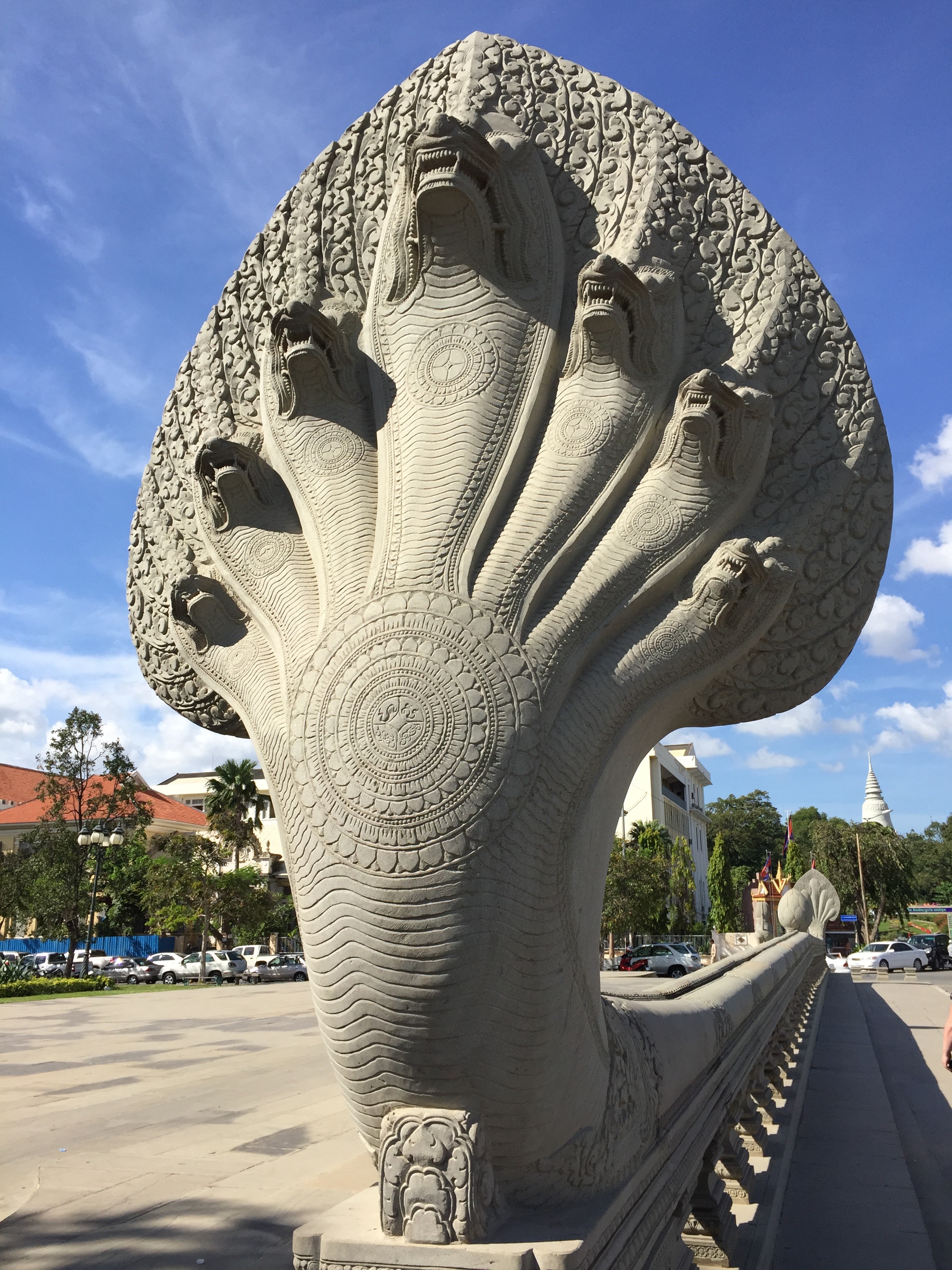 Phnom Pehn's architecture blends French and Cambodian/Khmer cultural styles. This stone balustrade along a bridge in Phnom Pehn uses the image of the mythical seven-headed serpent that represents power, water, and fertility in ancient Khmer culture.