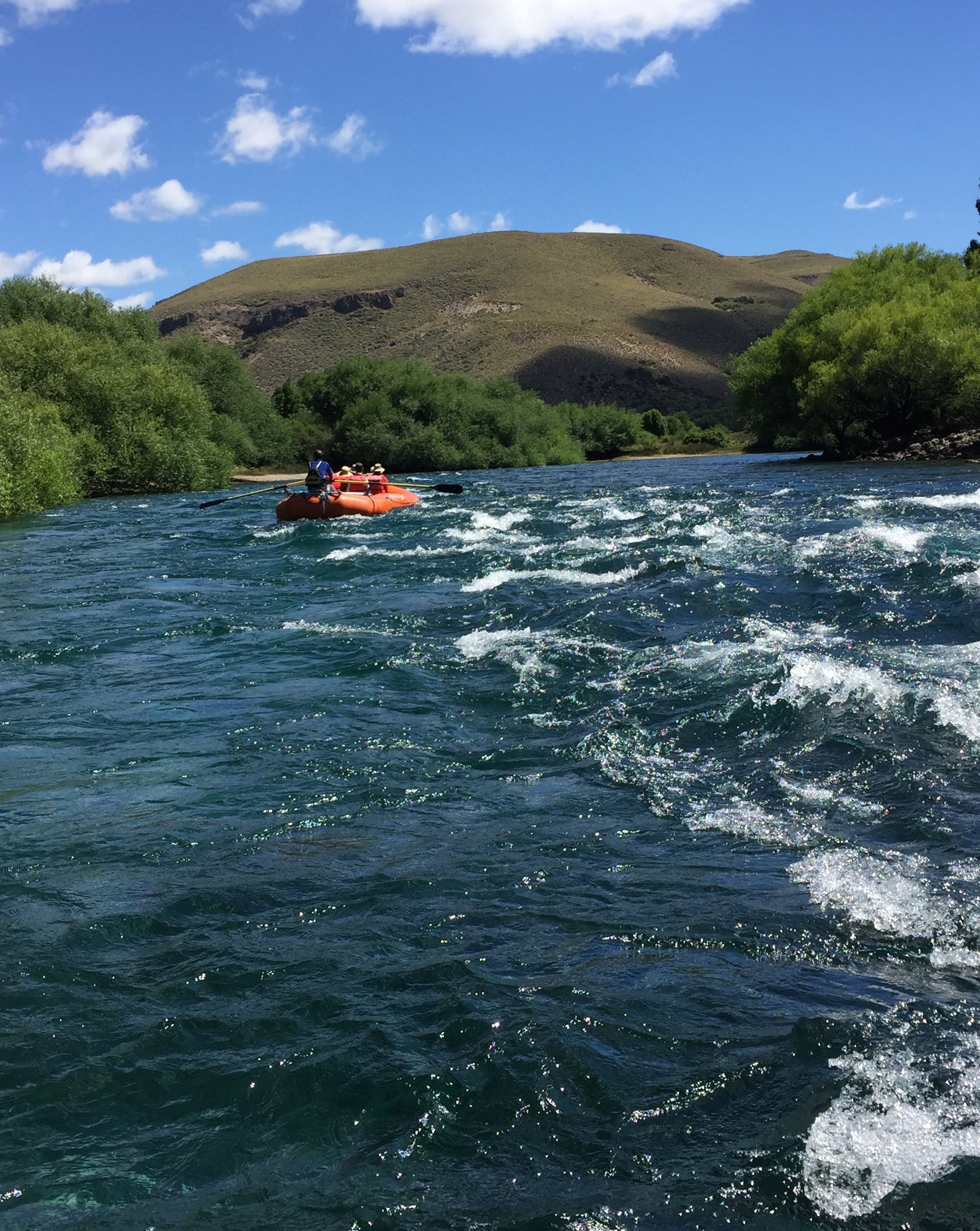 Enjoying a relatively calm raft trip down the beautifully clear Limay River.