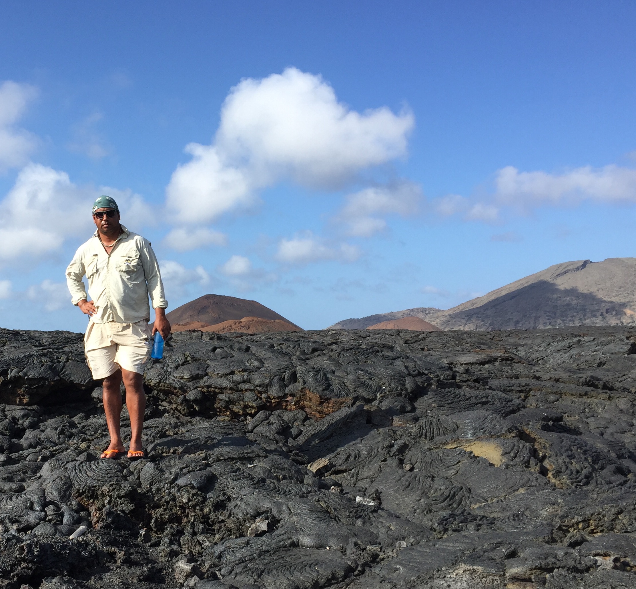 Our guide Wilo standing on a lava formation of Santiago Island