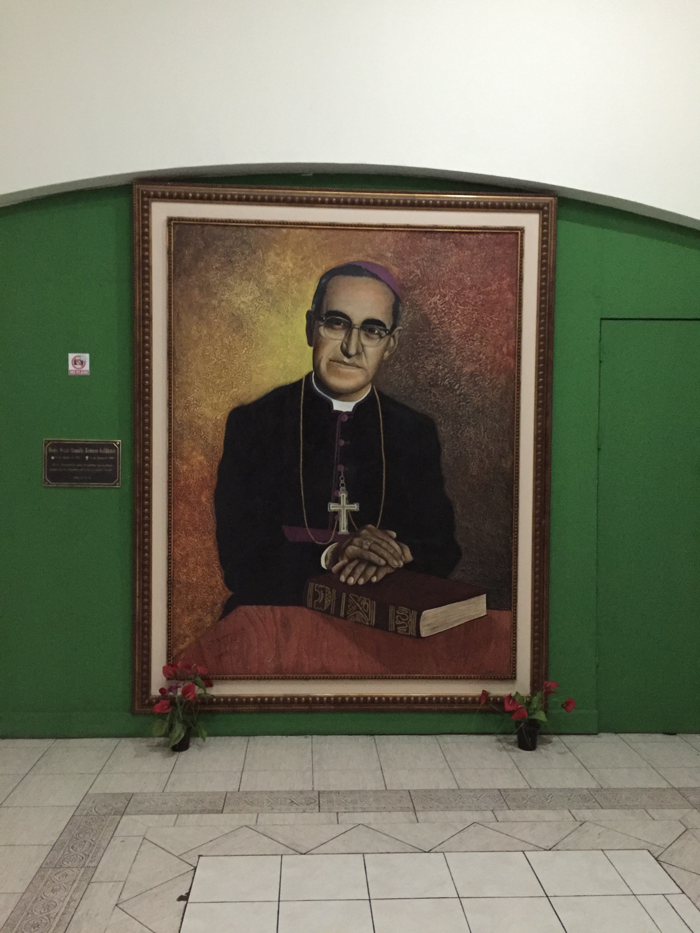A painting of Archbishop Oscar Romero in San Salvador Cathedral at San Salvador Cathedral. Archbishop Romero outspokenly opposed social injustice, assassinations and torture, which were being practiced by an El Salvadoran military junta that took power in 1979. He urged the US government to stop sending aid to the junta. He was assassinated in 1980. Shortly afterward, the Salvadoran Civil War ensued.