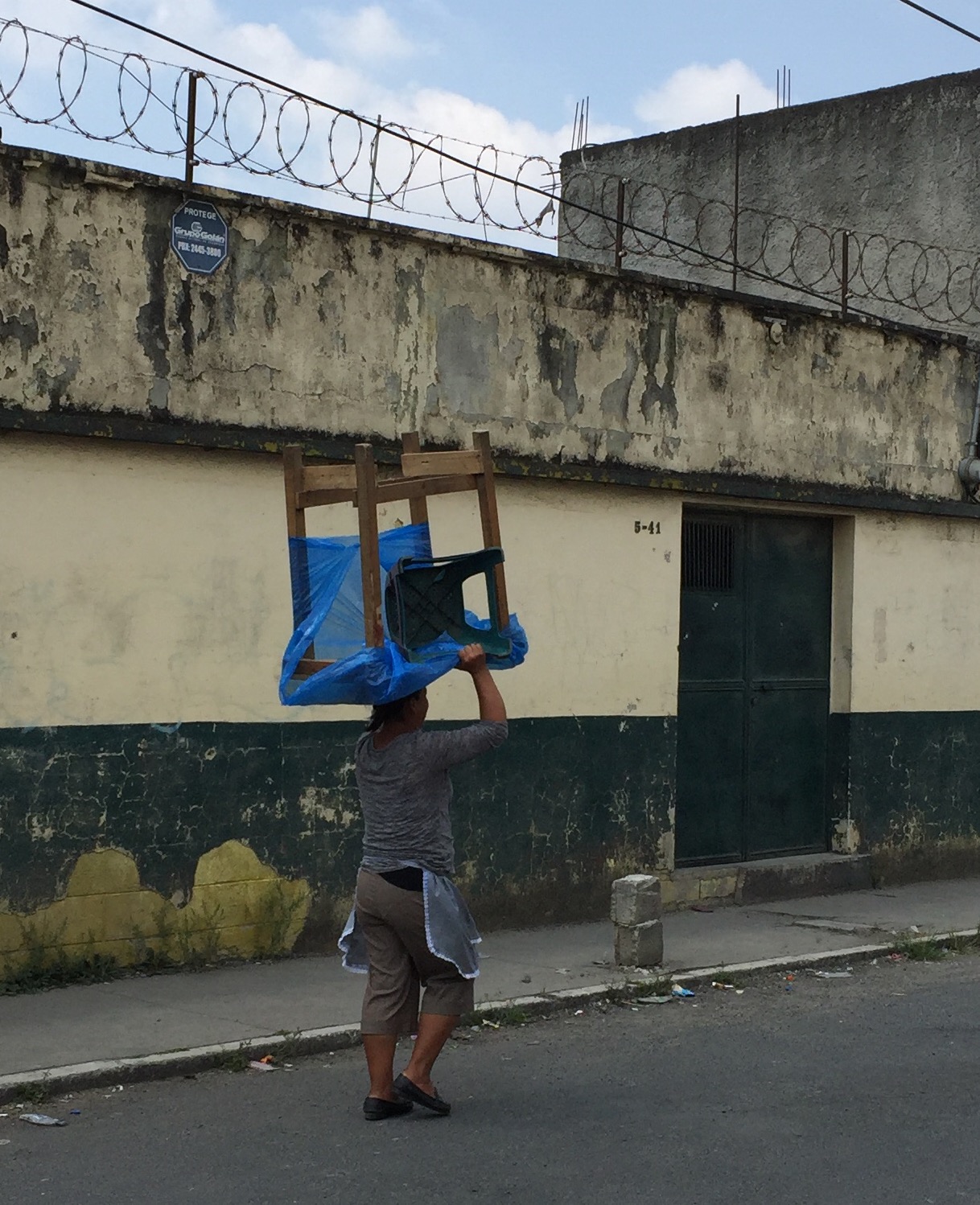 Woman carrying a scavenged item from the Guatemala City Garbage Dump in Zone 3.