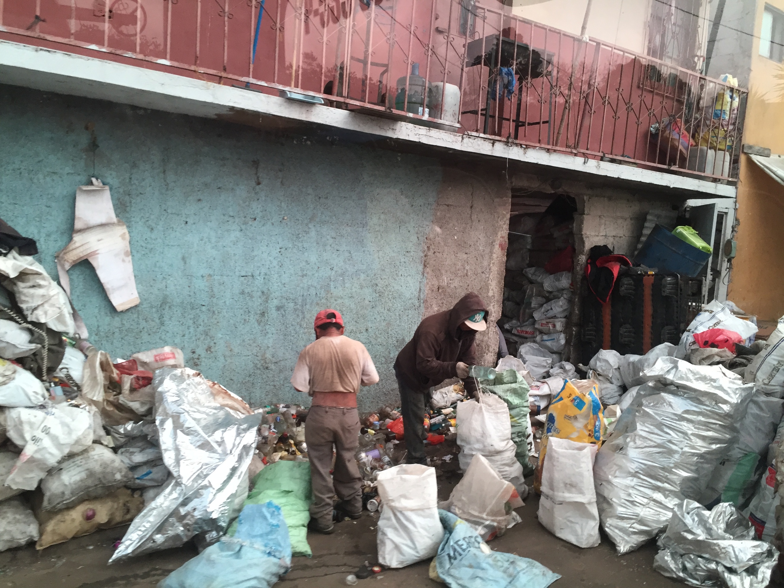 Men bagging recycables scavenged from the Guatemala City Garbage Dump.