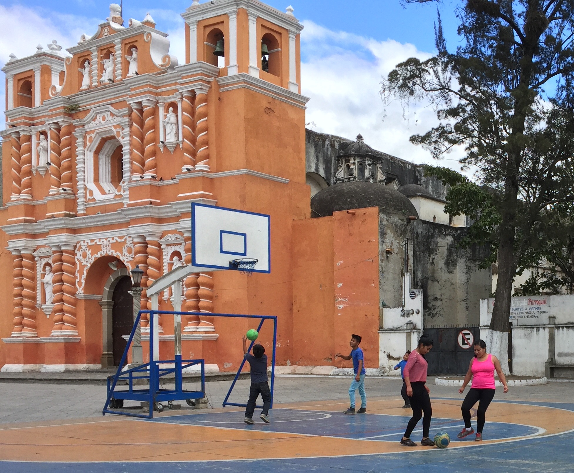 Kids playing basketball in front of the old convent in Antigua, Guatemala.