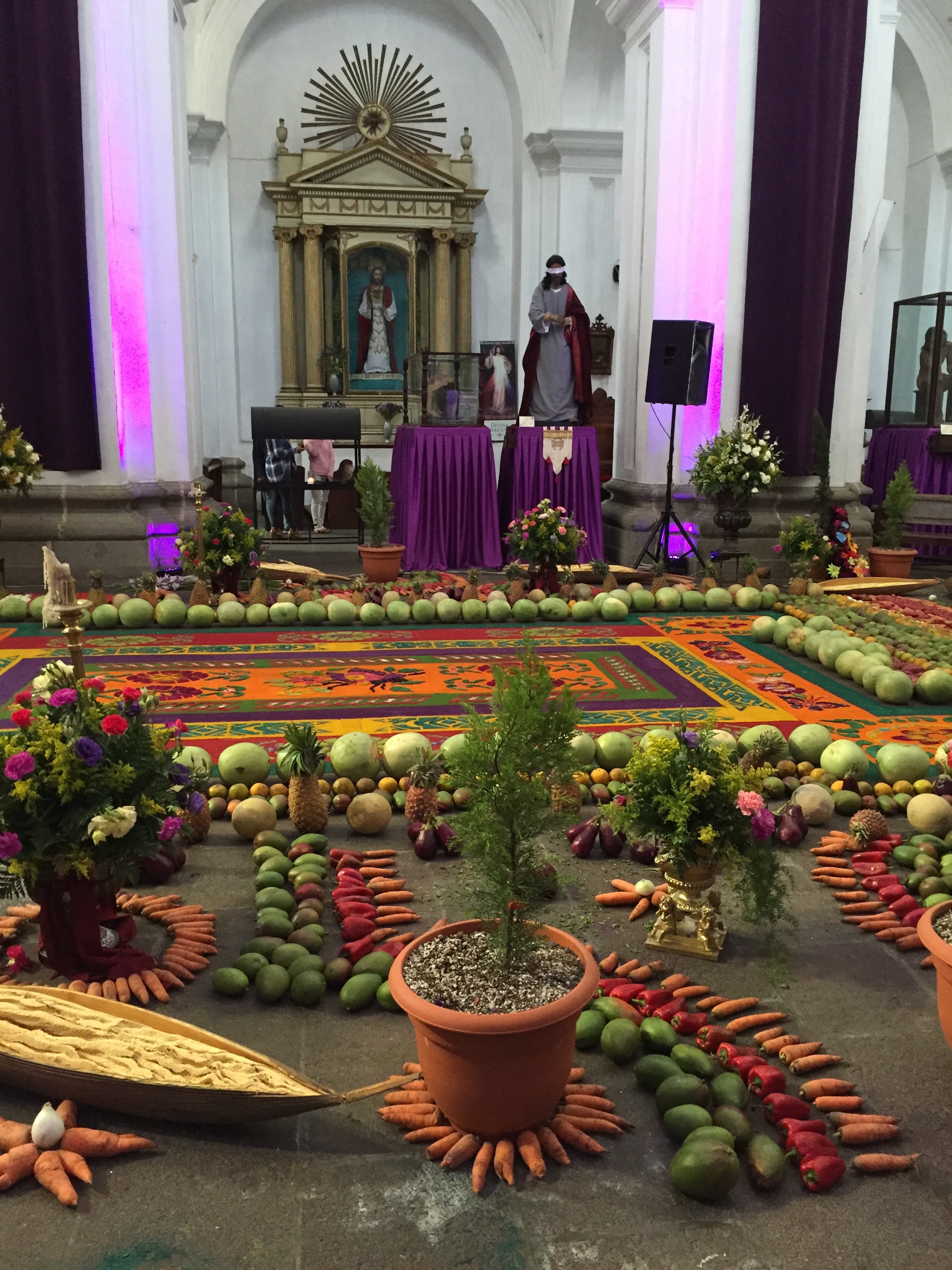A local church decorated in traditional style for Semana Santa week. Note the sawdust carpet and the cornucopia of fruits and vegetables.