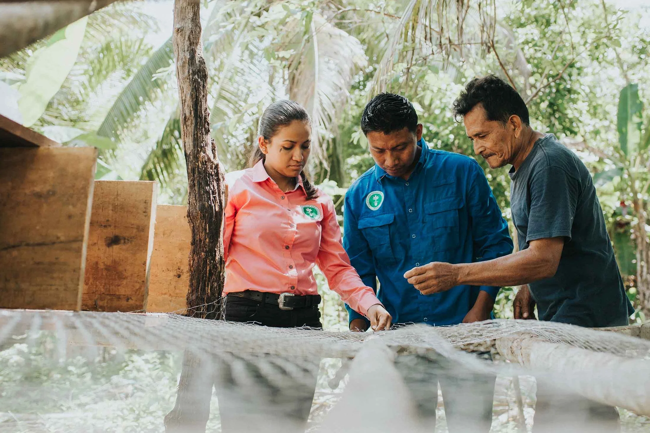 Hernando (R) builds an improved chicken coop with field trainers. - photo by Salt to Clay Photography