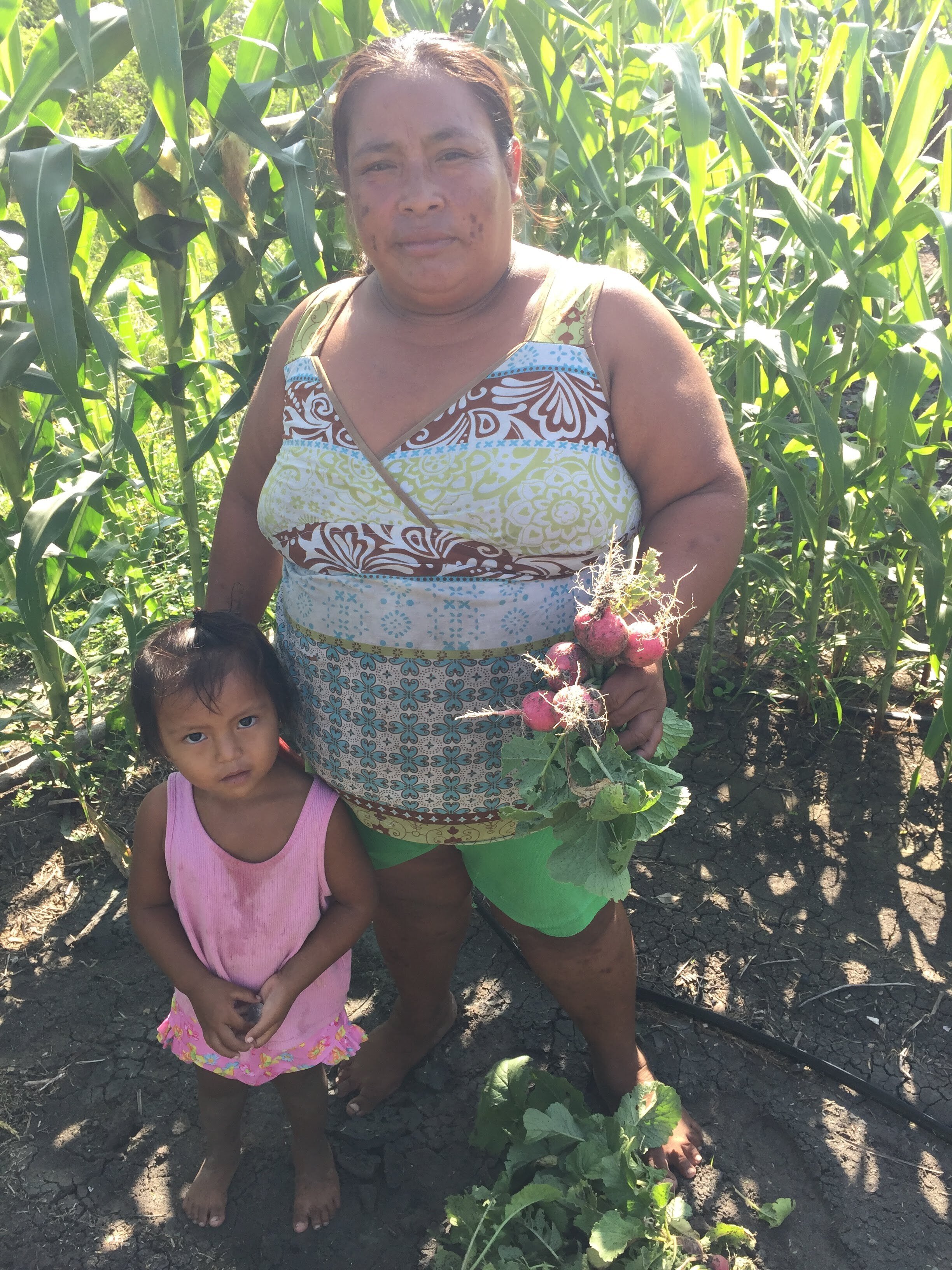 Maria Santos and her daughter, they harvested radish from her organic garden.jpg