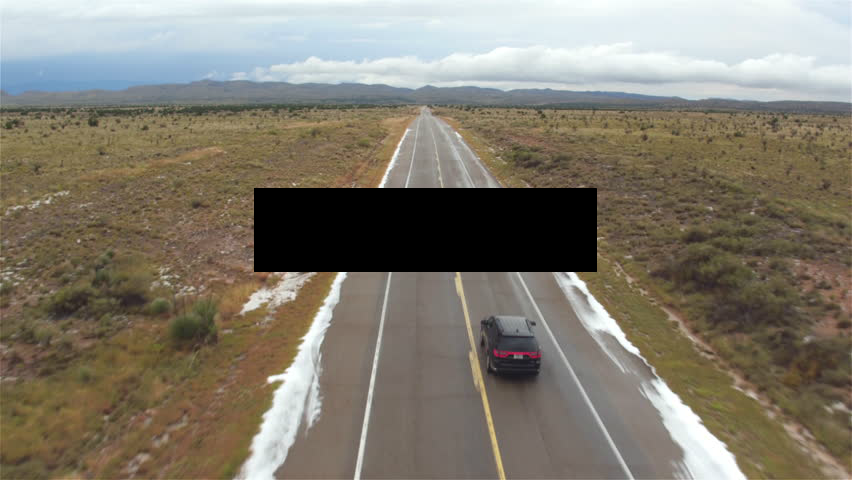 suv_driving_down_road_with_textbox.png