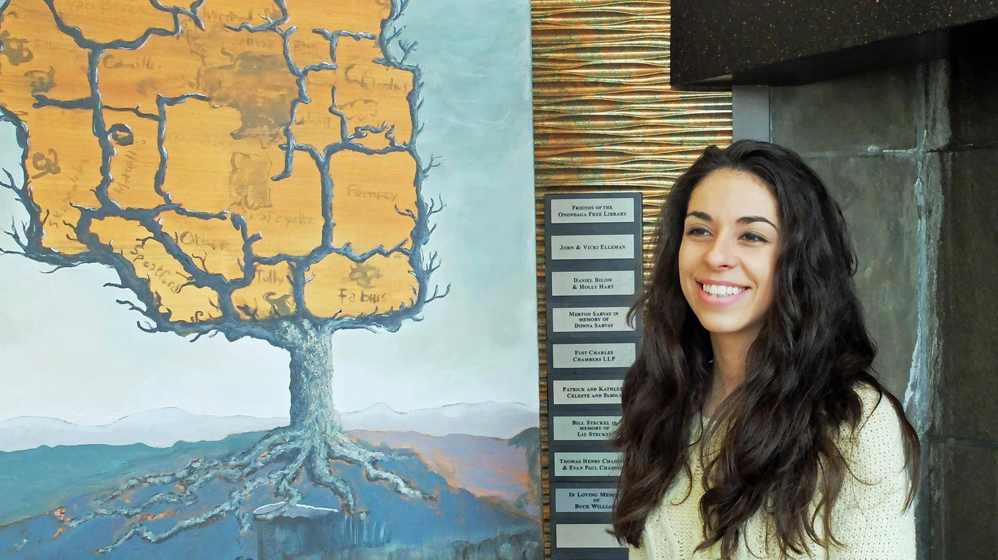 Maria Rizzo in front of the Onondaga Symbolic Tree, a community painting funded by the 2014 Individual Artist Grant from CNY Arts. Photo credits: Ray Trudell.