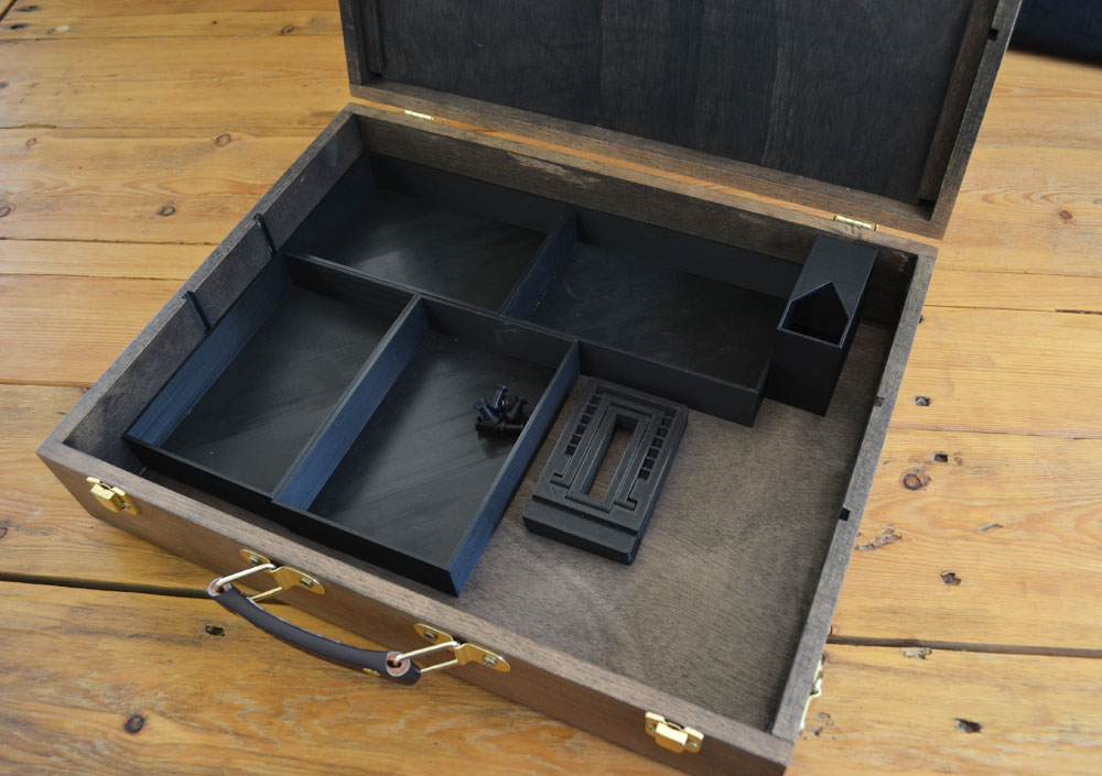 open, ebony GM chest with accessories inside, minus wooden dividers