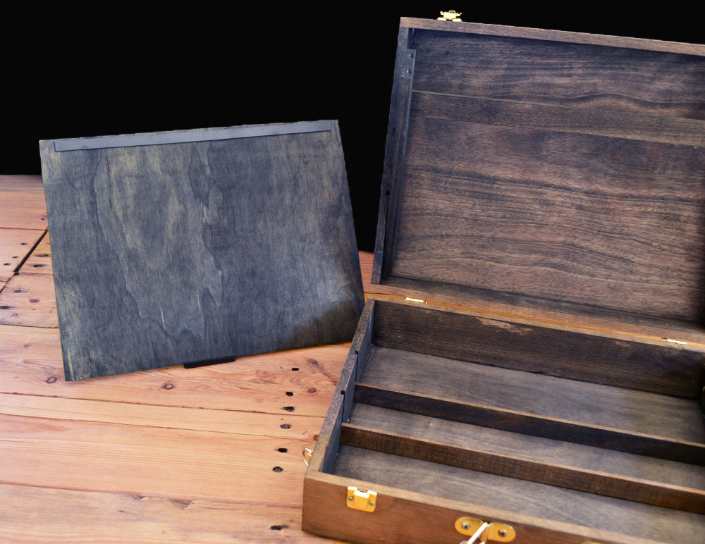 open gm chest with wooden dividers inside, wooden screen standing the the left of chest