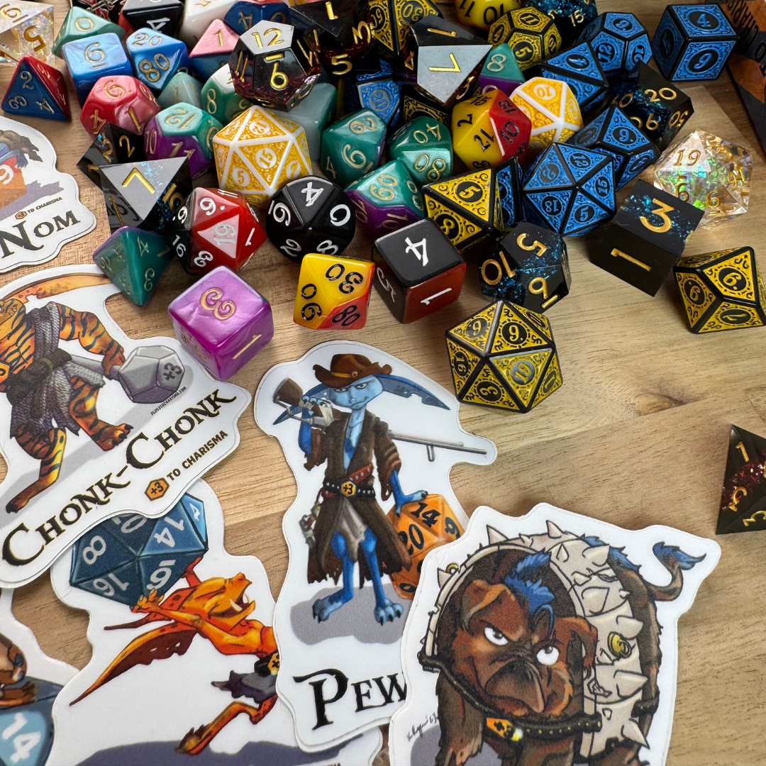 Mystery Boxes with dice goblin stickers, pins, and pretty dice