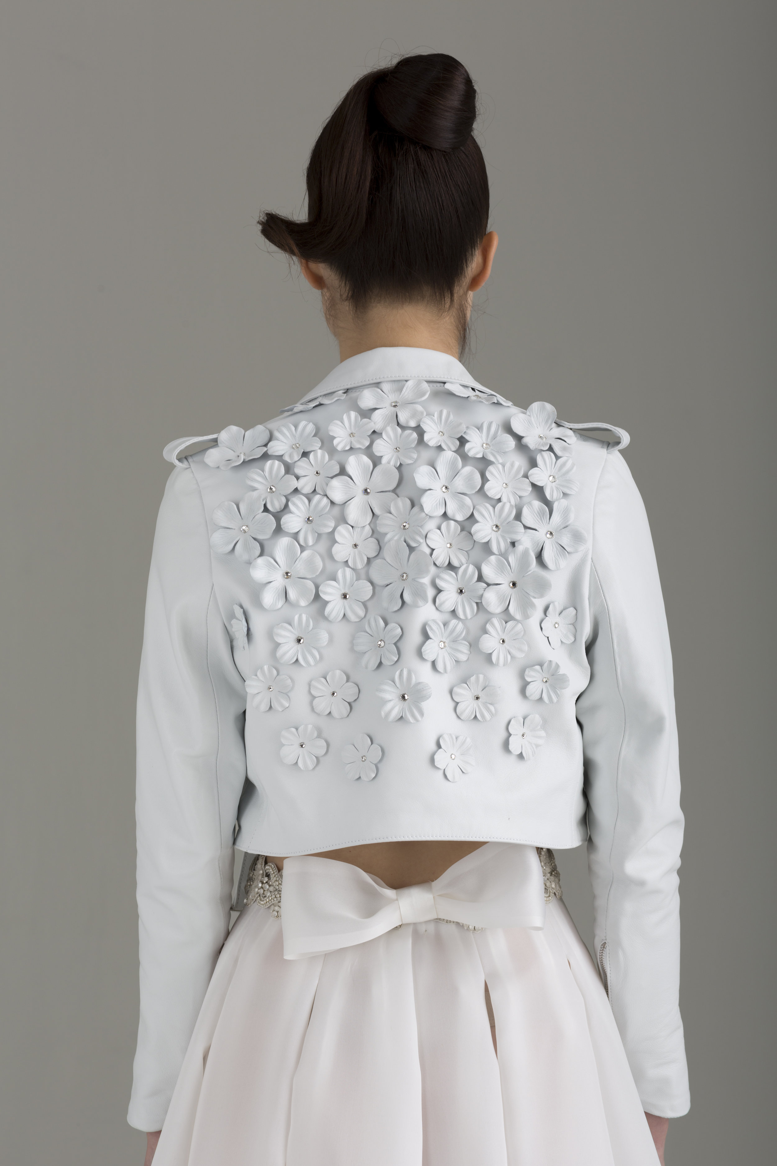    NKB17-84001    "Nathalie" Cropped Lambskin Leather MC Jacket Embellished w/ Hand-Made Leather Flowers &amp; Swarovski Crystals;  NKB17-81002  "Apoidea" Satin and Mesh Crop Top&amp;  NKB17-83006  "Magnolia" White Silk Gazar Multi Layers Pleat Skirt