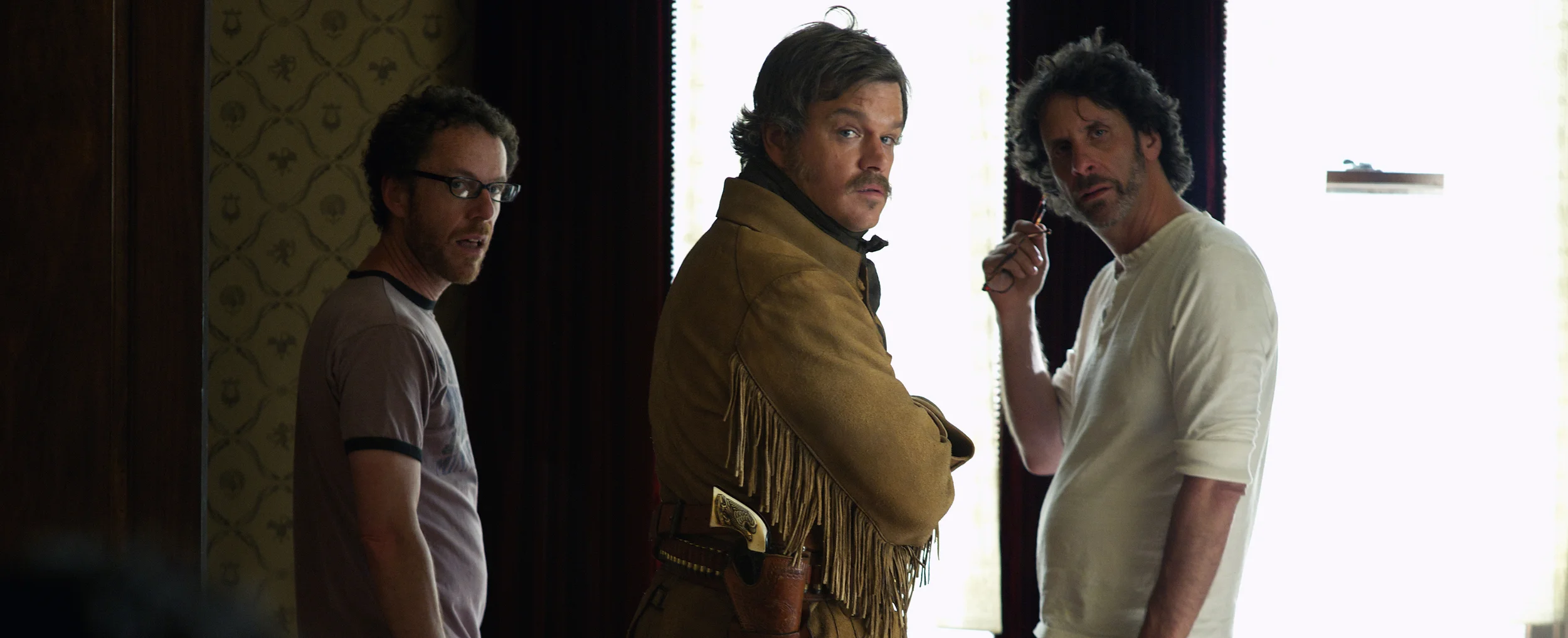 Directors Ethan and Joel Coen and Matt Damon on the boarding house set of True Grit (2010)