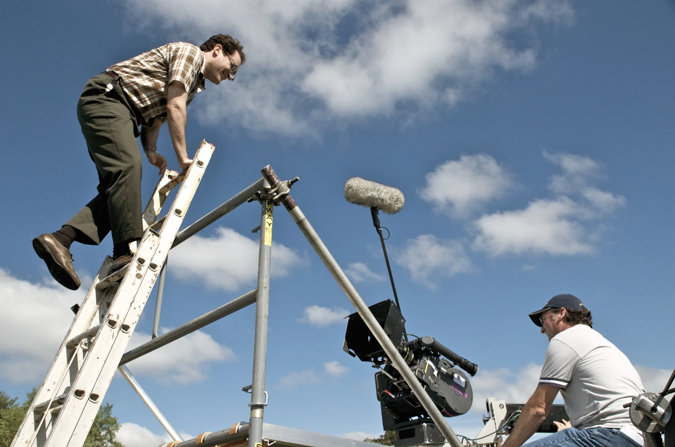 Michael Stuhlbarg on a ladder with 1st AC Andy Harris on the set of A Serious Man (2009)