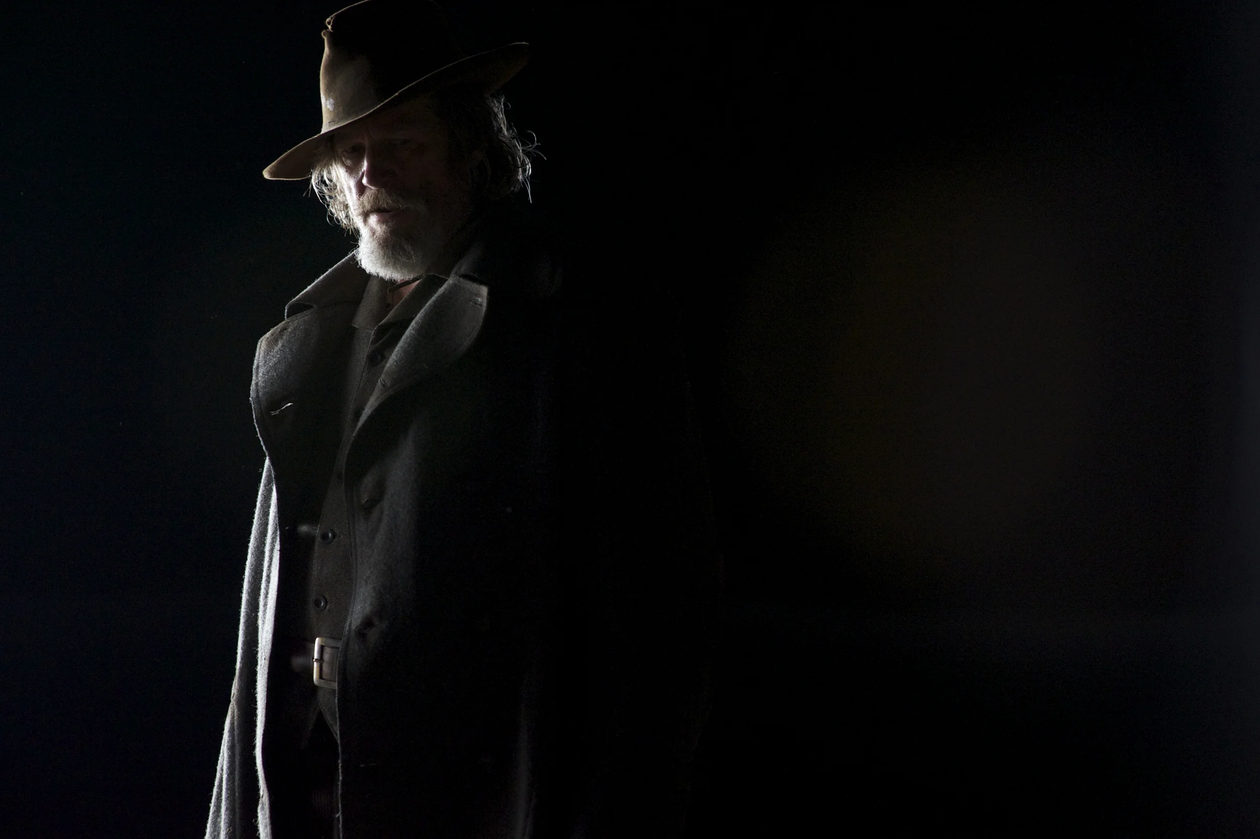 Jeff Bridges as Rooster Cogburn in shadows in True Grit (2010)